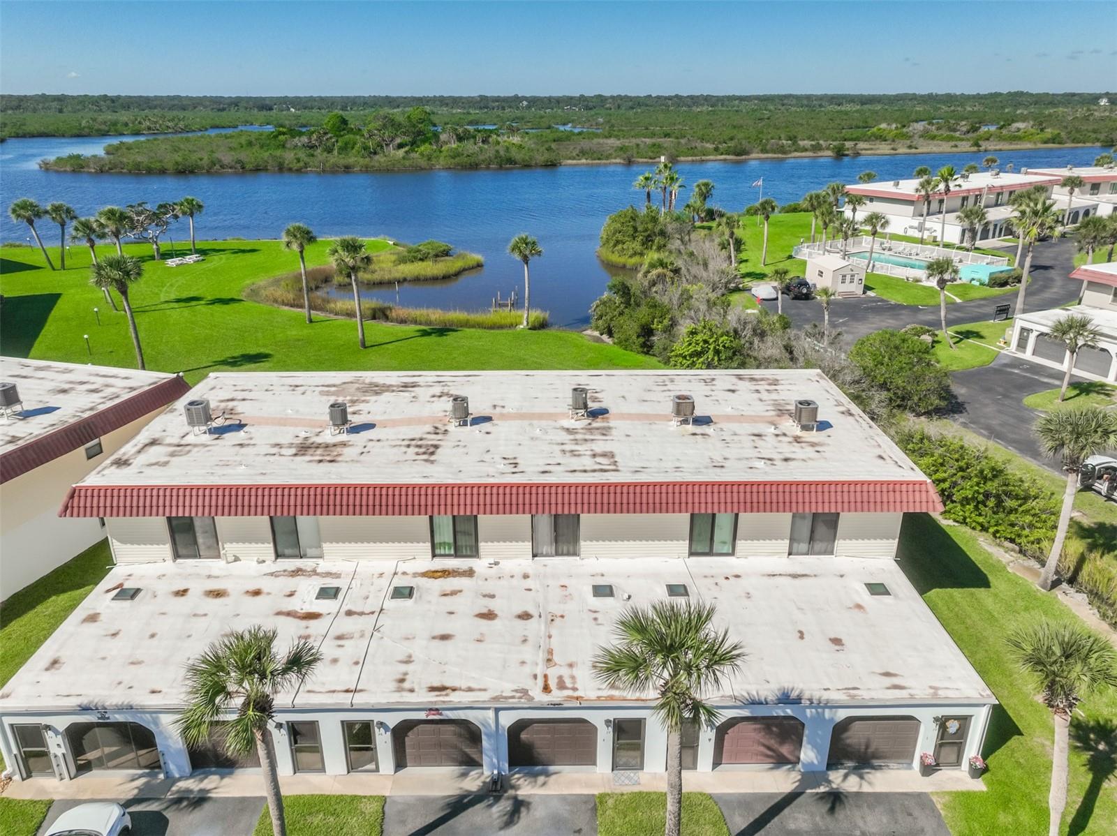 ?Experience coastal living at its finest in the desirable Ocean Palm Villas South community of Flagler Beach! Perfectly positioned near the Intracoastal Waterway and just a short stroll from the Atlantic Ocean, this beautifully updated two-story condo offers the best of both worlds, breathtaking waterfront sunsets and easy access to the beach for morning sunrises. Step inside to discover a welcoming coastal retreat featuring a tastefully renovated kitchen with updated countertops, soft-close cabinetry, and convenient under-stair storage. Both bathrooms have been thoughtfully modernized with stylish finishes. The first-floor patio provides the perfect setting to unwind, complete with a retractable awning for added afternoon shade. Upstairs, the primary bedroom opens to a private waterfront balcony where you can relax while taking in picturesque water views, spectacular sunsets, and the surrounding wildlife. Additional highlights include a NEW ROOF INSTALLED IN 2025 and a flood prevention system installed by Garrison Systems, featuring protective barriers at the sliding glass door and interior garage door for an added layer of protection. Enjoy the convenience of low-maintenance living with association fees covering exterior building maintenance and insurance, grounds maintenance, community pool access, water, trash, internet, cable television, and more. Newly redone pickleball & tennis courts. Whether you're searching for a full-time residence or a relaxing coastal getaway, this waterfront gem offers an incredible opportunity to embrace the laid-back Flagler Beach lifestyle!