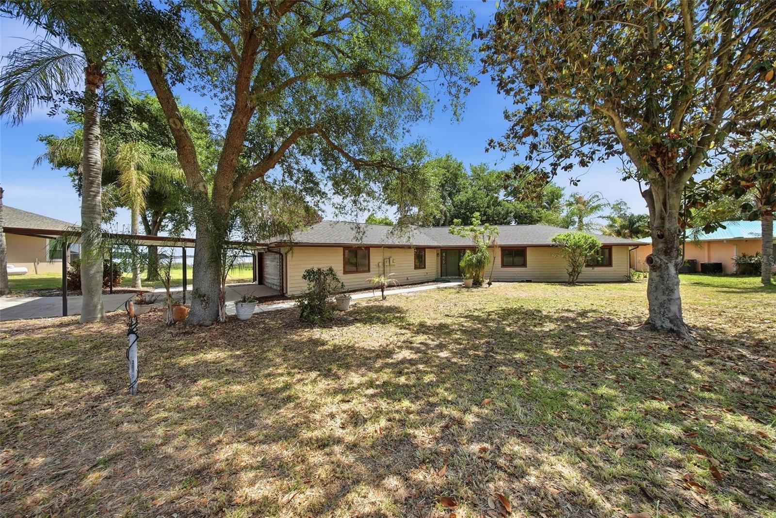 Lakefront Opportunity on Lake Haines – Over 1 Acre with No HOA!Discover the potential of this charming rustic-style lakefront home located in the city of  Lake Alfred, offering breathtaking views of Lake Haines. Situated on over one acre of land, this property offers the freedom and space to create your dream home.This 3-bedroom, 2-bathroom home also includes a dedicated office, spacious living and dining areas, and a cozy fireplace. The interior features high ceilings, beautiful wood beam accents, and a unique circular ceiling design that adds character and warmth. Ceramic tile flooring runs throughout the home.Enjoy stunning lake views from multiple large windows, a screened-in porch, and a wraparound wooden deck—perfect for relaxing with your morning coffee or entertaining guests. The property also includes a private long dock with covered boat slip, ideal for experiencing true lakefront living.Additional features include a garage and carport for two vehicles, laundry room, and two storage units. Recent updates include a new roof, new A/C ductwork, some new windows and glass doors, and the home has been recently painted exterior.The home offers timeless rustic charm and solid construction, presenting an excellent opportunity for a buyer to update and customize it to their own taste.The highlight of this property is truly the incredible lake views, expansive lot size, and peaceful setting. Also this lot is splittable and you can build your in-laws house next to you.Conveniently located in Lake Alfred, a growing Central Florida community known for its Chain of Lakes, small-town charm, and easy access to major cities. Enjoy being just a short drive from Orlando and Tampa, with nearby shopping, dining, and outdoor recreation.Call today for a private showing!!
