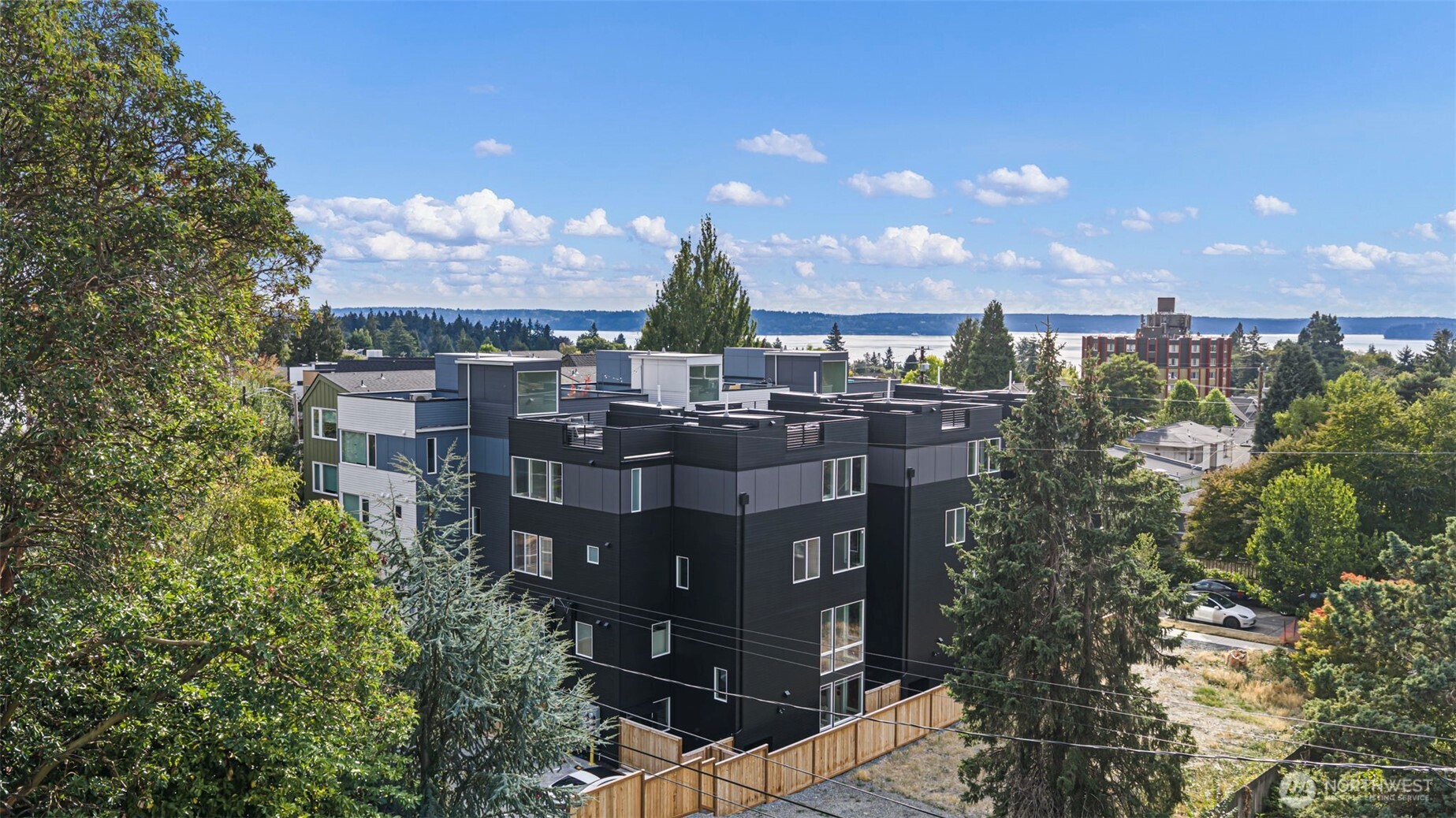 Morgan Junction - Brand-new 2026 construction, ready now. Unit F is the rear end home at Fauntleroy Landing — one shared wall, 3 bed, 2.75 bath, 1,444 sq ft across four levels. Showpiece kitchen: Café matte-white appliances with brushed bronze hardware, matte charcoal cabinetry with a warm walnut accent bank, quartz counters and stacked vertical tile backsplash. Wide-plank floors. Soaring two-story window wall floods the living area with light. Two bedrooms and a full bath on the third level; the primary suite has the entire top floor to itself — a true private retreat. Rooftop deck plus your own rear patio. Heat pump heats AND cools. Washer and dryer included. Fee-simple unit lot: you own your land, NO HOA DUES, and a dedicated parking stall. Two blocks to the RapidRide C Line and Morgan Junction. SELLER CREDIT — 1%, buyer's choice: closing costs, prepaids, or points to buy the rate down further. SPECIAL FINANCING: 1% first-year buydown paid by our preferred lender — stacks with the credit.