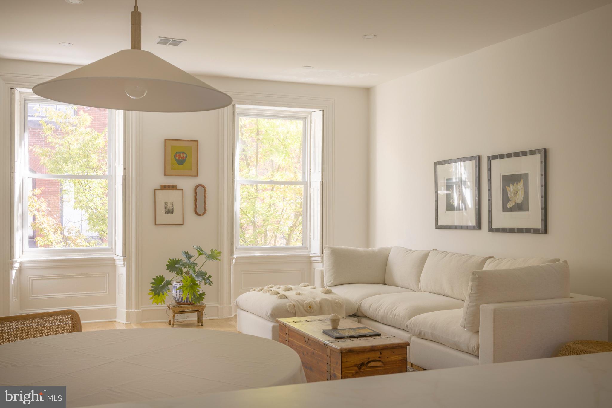 Come tour this fully renovated 2-bedroom, 1.5-bath bi-level condominium on a quiet, tree-lined street in the heart of Rittenhouse Square. Set on an upper floor and offering over 1,100 SF, Unit #3 pairs modern updates, including all new electrical and HVAC, with original charm and character throughout. The foyer steps up to an open floor plan with white oak hardwood floors, recessed lighting, and large windows that bring in tons of natural light and tree views. The kitchen features quartz countertops, a full suite of stainless steel appliances, and a breakfast bar. The sizable living room is anchored by a marble mantel fireplace. A carefully restored staircase features 100% wool and jute runners. Upstairs, two well-proportioned bedrooms each offer two closets, a fireplace set against exposed brick, and room for king or queen-sized beds. The updated full bath on this level pairs a white oak vanity with marble-look quartz top and brushed brass fixtures, and a tub framed in vertically stacked terracotta tile. The bathroom also offers a heated marble basketweave mosaic floor and a window with custom shutters. Other features include a powder room with washer and dryer and extra storage space just below the first level.  Blocks from Rittenhouse Square, the Avenue of the Arts, the Broad Street Line, and the neighborhood's best restaurants, cafes, and shops close at hand.