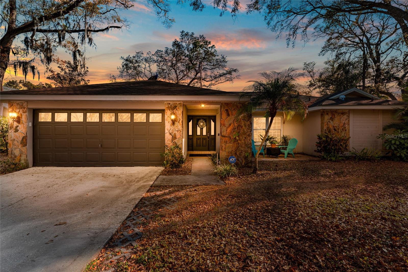 Discover a rare opportunity to own a piece of the sought-after Spanish Manor subdivision, a premier Dunedin, Florida, enclave known for its mature landscaping and oversized lots. This meticulously maintained estate offers the ultimate combination of privacy, durability, and modern functionality on an expansive, quarter-acre wooded lot. Providing a shaded sanctuary that is increasingly difficult to find in the Pinellas County market, this residence boasts striking curb appeal that perfectly matches its lovely interior. Constructed with enduring concrete block and accented by elegant stone masonry, this home offers peace of mind with a new roof replaced in 2024. The property features 2,084 square feet of refined living space (2,846 square feet under roof) and a spacious 2-car attached garage. The interior is defined by a functional and flexible floor plan designed for modern living, where open, adaptable spaces transition effortlessly from quiet relaxation to grand-scale entertaining.Upon entering, you are greeted by a formal dining room and dinette that lead into a "soaring" open-concept living area. The heart of the home is a chef’s kitchen equipped with timeless hardwood cabinetry, sleek Corian countertops, and a central breakfast bar island. The interior finishes include a refined mix of warm wood flooring in the main living areas, durable ceramic tile in high-traffic wet areas, and plush carpet in the bedrooms for ultimate comfort. Both bathrooms have been updated with matching hardwood cabinets topped with elegant granite counters.The thoughtful split floor plan ensures maximum comfort for all, with a primary suite featuring direct access to a covered porch. For seamless Florida living, the secondary bathroom doubles as a pool bath, offering direct access to the screen-enclosed pool area to keep the main living spaces pristine. Large pocket sliders disappear to merge the interior with the pool lanai, creating a harmonious indoor-outdoor flow perfect for enjoying the Florida sun.Located in the heart of Dunedin, one of the most charming waterfront towns on the Gulf Coast, this home is minutes away from an unparalleled lifestyle. Residents enjoy quick access to the pristine sands of Honeymoon Island and Caladesi Island State Park, as well as the 38-mile Pinellas Trail. The vibrant, walkable Downtown Dunedin district offers a unique blend of open-air breweries, boutique shopping, and award-winning dining. As part of the thriving Tampa Bay region—a top national destination in 2026—this location offers proximity to a robust economy, professional sports including Toronto Blue Jays spring training, and a world-class arts scene. This Spanish Manor property is a standout choice for those seeking a durable, move-in-ready home in a prime Tampa-St. Petersburg area location.