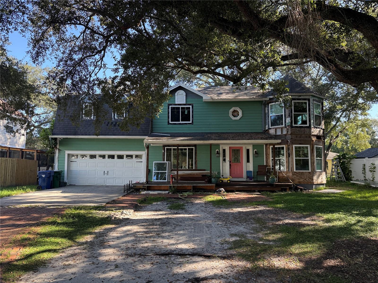 **SOUTH TAMPA RENOVATION OPPORTUNITY WITH DISTINCTIVE ARCHITECTURAL CHARM!** Bring your vision and finishing touches to this spacious 3-bedroom, 2.5-bath, 2,384-square-foot, two-story home featuring Dutch Colonial-inspired architecture, existing upgrades, and exciting renovation potential! From the distinctive gambrel-style roofline and charming dormer windows to the welcoming covered front porch and striking two-story bay window feature, this home offers architectural character that sets it apart.Inside, you'll find wood flooring, generous living spaces, and a kitchen featuring granite countertops, tall espresso-finished wood cabinetry, stainless steel appliances, and a spacious breakfast bar. The primary suite features a remarkable turret-style sitting area surrounded by windows, highlighted by a dramatic vaulted, wood-planked ceiling with exposed architectural beams. The primary bathroom offers a double-sink vanity, updated tilework, and a separate tub and shower.Additional features include a two-car garage, wood deck, covered front entry, and beautiful mature shade trees. New Simonton StormBreaker Plus hurricane-impact-rated windows have been installed (Missile D Certified), providing a significant head start on the renovation. Window trim, finishing work, and final permit approval remain incomplete and are the buyer's responsibility.**INVESTOR AND RENOVATION BUYER OPPORTUNITY! PROPERTY IS BEING SOLD STRICTLY AS-IS IN ITS CURRENT, UNFINISHED CONDITION.** The existing roof needs replacement. Exterior siding, window trim, interior finishing, and additional repairs and improvements remain incomplete. The window installation permit has not been finalized, and the buyer will be responsible for completing the required work and obtaining permit closeout, subject to applicable permitting authority requirements. Seller will not complete repairs or renovations prior to closing.Discover the potential to restore and personalize this architecturally distinctive home in an established South Tampa location. Bring your contractor and imagination—this is an opportunity to create something truly special! STOVE DOESN'T CONVEY.
