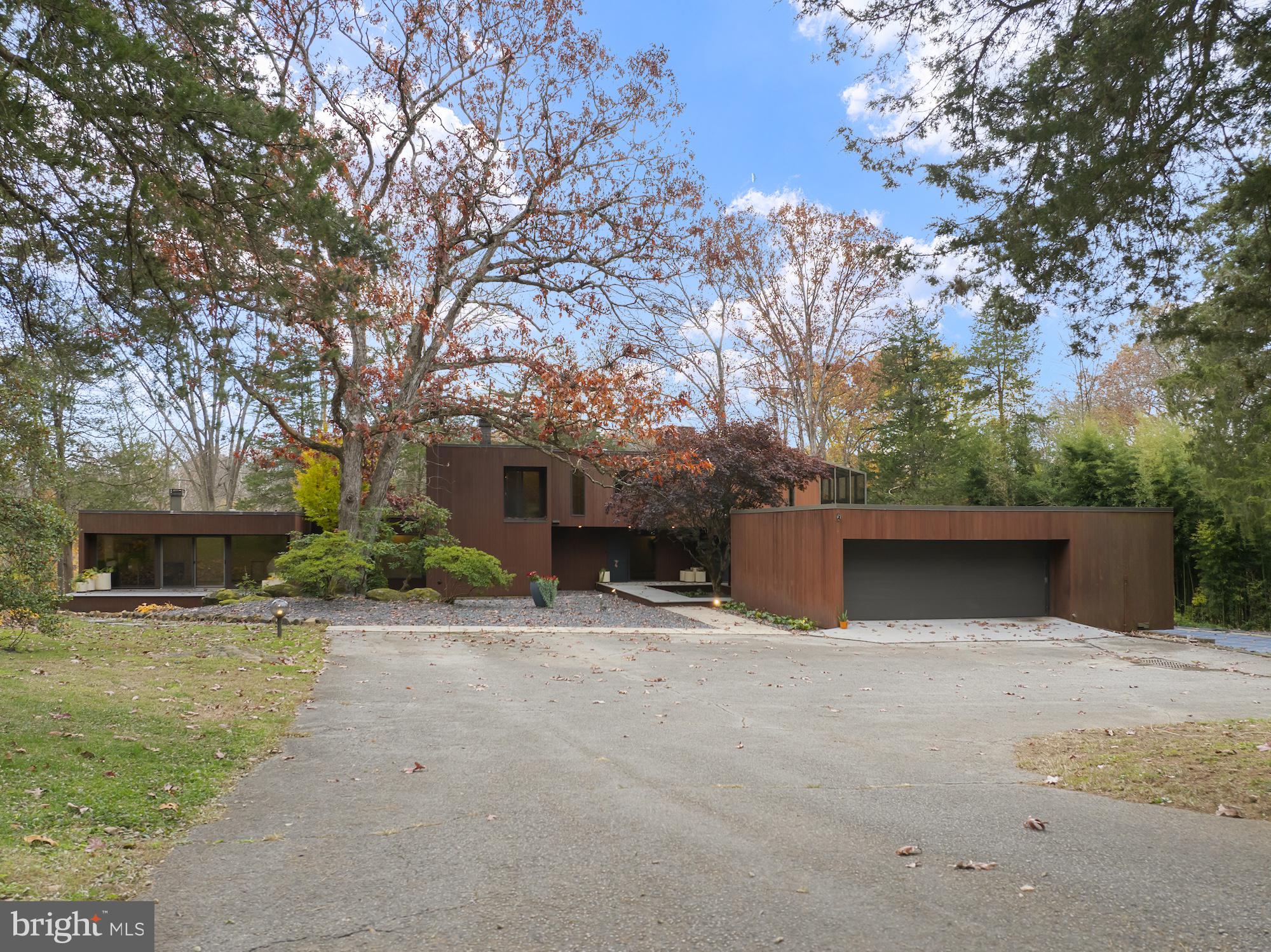 Secluded Contemporary Retreat on 8+ Acres! Discover this 3,637 sq. ft. contemporary home nestled among mature woods with outdoor recreational area along Bermudian Creek/Stream, ponds with fountains, and an in-ground pool featuring a new liner and slate patio surrounded by bamboo. Enjoy the hot tub and expansive composite deck for year-round relaxation. The upper-level primary suite offers a private sunroom with slider access, office space with built-ins, double vanity bath with jetted tub, walk-in shower, numerous built-ins and a Finnish sauna. Three wood-burning fireplaces, skylights, tinted windows, and sliders in nearly every room fill the home with natural light. The main level includes two bedrooms with a Jack and Jill bath, a sunken family room with fireplace, and a game room with wet bar. The contemporary kitchen features stainless steel appliances, granite countertops and island with convenient laundry access with utility sink. Oversized garage, spiral staircase, abundant lighting, and a truly private setting perfect for hiking and outdoor recreation. Located just minutes from East Berlin, this one-of-a-kind property blends modern design with nature’s serenity.