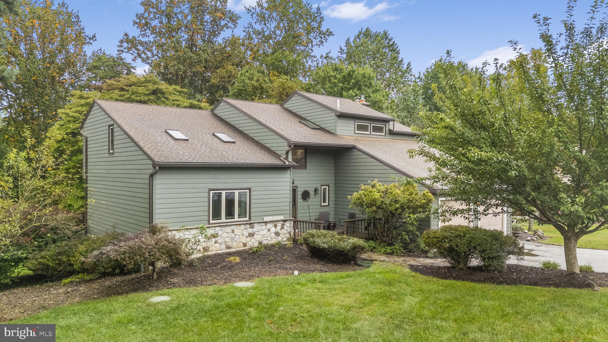 Welcome to 9 Fox Ridge Road, a spacious 4-bedroom, 2.5-bath contemporary home set on a beautiful 1-acre lot in Glenmoore. This inviting home offers 3,142 square feet of above-grade living space, with an open and versatile layout designed for everyday living and entertaining. The main level features a dramatic two-story foyer, spacious living and dining rooms with beautiful wood flooring, and a large eat-in kitchen with abundant oak cabinetry, pantry storage, tile flooring, and stainless-steel appliances. The kitchen opens to a bright breakfast area with sliding glass doors leading to the expansive rear deck, creating an easy connection between indoor and outdoor living. The adjoining family room features a striking floor-to-ceiling stone fireplace with a wood-burning stove and additional access to the deck. Upstairs, four generously sized bedrooms include a spacious primary suite with a walk-in closet and private bath featuring dual sinks, a skylight, whirlpool tub, and separate shower. The additional bedrooms share a full hall bath. The full walkout lower level offers a large recreation room, substantial storage space, and direct access to the outdoor areas, providing excellent flexibility for recreation, hobbies, or additional living space. Outside, enjoy the peaceful wooded surroundings, multiple outdoor entertaining areas, expansive decking, and mature landscaping. Additional highlights include a 2-car attached garage, main-level laundry, central air, a newer water heater installed in 2024, and a convenient location with easy access to Route 100, the Pennsylvania Turnpike, Route 401, Route 30, and nearby regional amenities. A wonderful opportunity to own a spacious home with privacy, character, and versatile living spaces in Glenmoore.