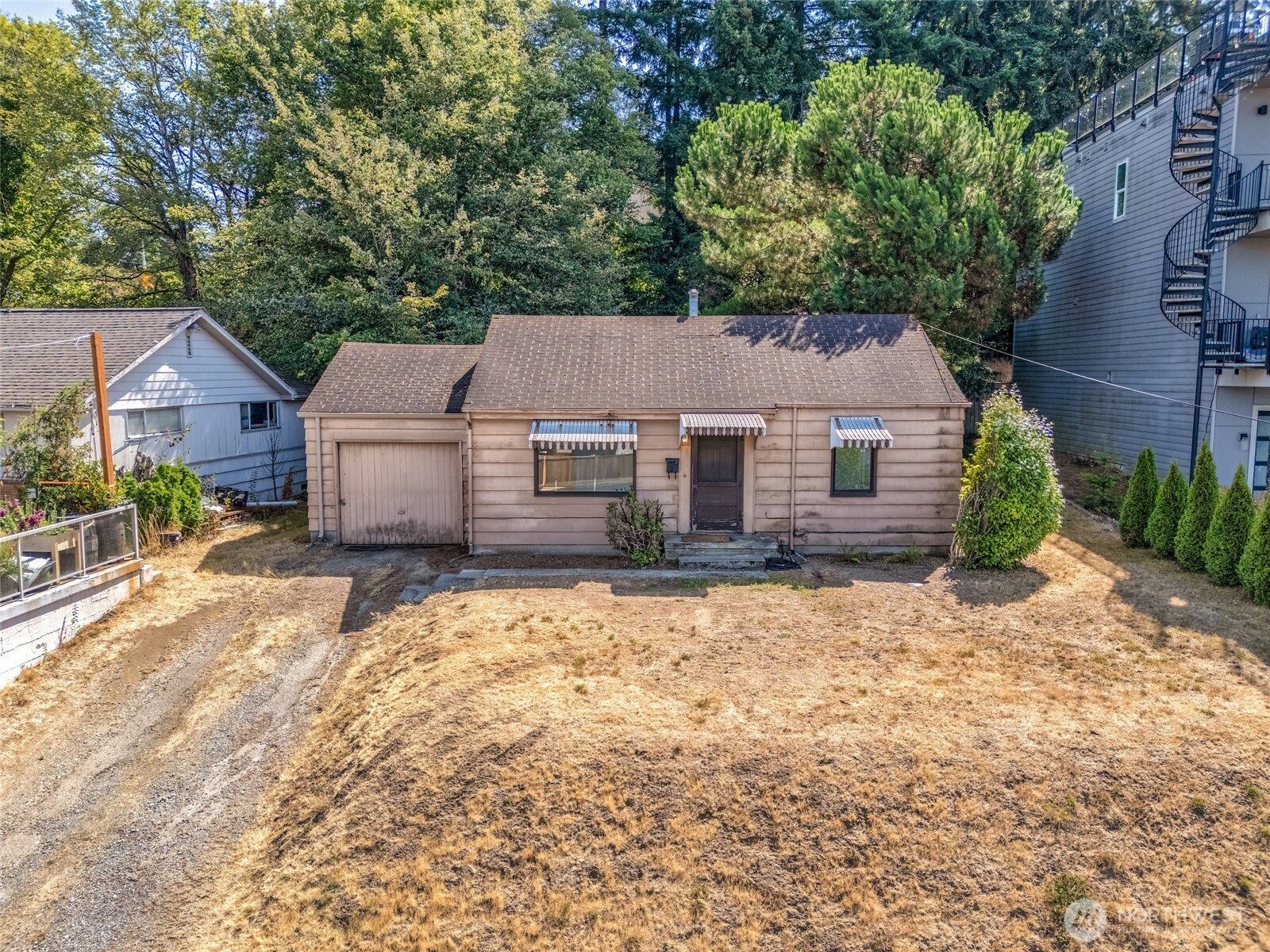 Lake Washington views, a generous lot, and incredible potential come together in this charming 1943 Renton bungalow! Situated on an approximately 8,283 sq. ft. lot, this 2-bedroom, 1-bath home offers an exciting opportunity to renovate, personalize, and create something truly special. Step inside to discover original hardwood floors and vintage character ready to be refreshed and brought back to life. Enjoy territorial and Lake Washington views, abundant garden space, and a spacious yard with plenty of room to relax, entertain, or create your own outdoor retreat. A one-car garage provides convenient parking and additional storage. Located near Windsor Hill Park and just minutes from The Landing, shopping, dining, Lake Washington recreation, Boeing, I-405, Hwy 167, and SeaTac Airport. Whether you’re a first-time buyer with a vision, an investor searching for your next project, or someone looking for a well-located home to make your own, this property offers a rare combination of location, character, outdoor space, and opportunity. Bring your ideas and imagine the possibilities! Selling AS-IS, Seller to do no repairs. Virtually staged.
