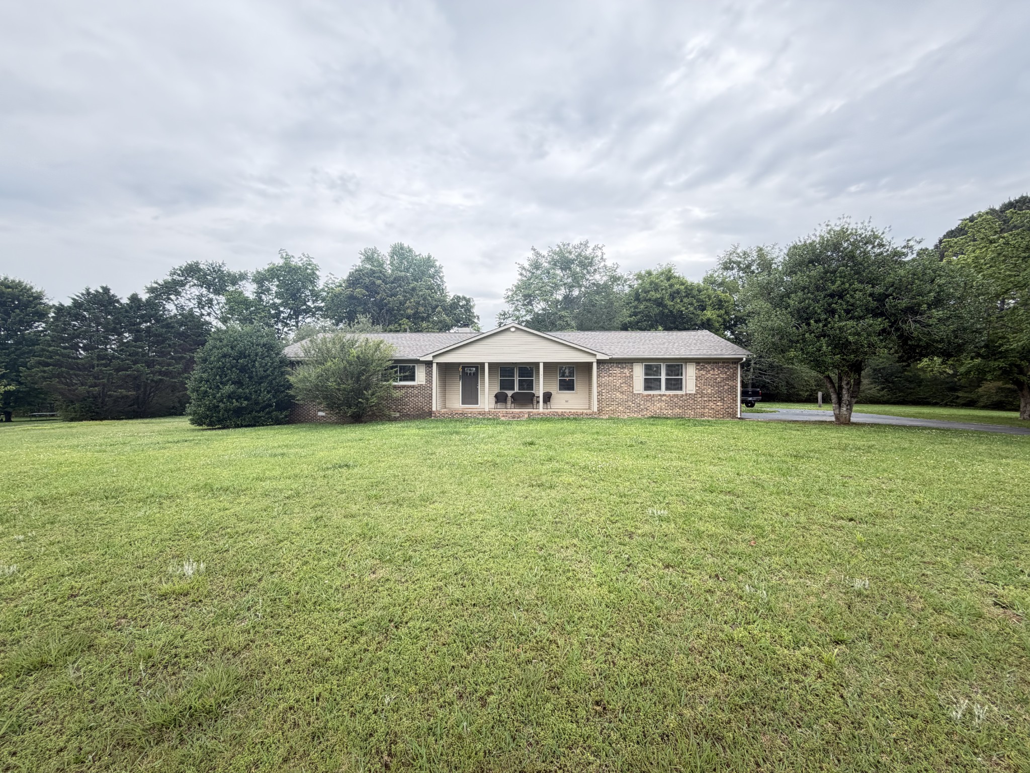 Welcome to this well-maintained 3 bedroom, 2 bath brick home situated on 1.3 acre lot in a quiet well-established neighborhood just minutes from the lake. This charming property offers the perfect balance of privacy space and convenience, making it ideal for families, downsizing, or anyone looking to enjoy peaceful living close to outdoor recreation. The home features a bright and inviting living room, a well-appointed kitchen with plenty of counter and cabinet space, and a dining area perfect for everyday meals and entertaining. The primary bedroom includes a private full bath, while two additional bedrooms provide flexibility for guests, family members, or a home office. Step outside to enjoy the screened in back porch, providing the perfect space to relax, entertain, or enjoy the outdoors while staying protected from the elements. The expansive 1.3-acre lot offers plenty of room for outdoor activities, gardening, or simply enjoying the peaceful surroundings. The classic brick exterior adds timeless curb appeal and durability or low-maintenance living.