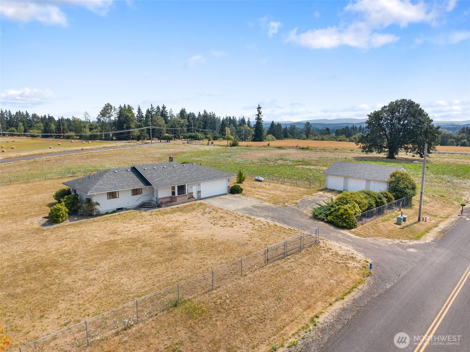 Rare combination of peaceful country living and exceptional long term INVESTMENT & DEVELOPMENT potential! Set on 5.72 acres just minutes from downtown Toledo and I 5, this beautiful property offers a quiet country setting with impressive views of both Mt. Rainier and Mt. St. Helens, while remaining convenient to the Cowlitz River, state parks, recreation, and everyday amenities. Enjoy the acreage, privacy, and country lifestyle exactly as it is today, or take advantage of the property’s R2 ZONING and explore future development possibilities including duplexes, townhomes, fourplexes, ADUs, and small multifamily uses, subject to City requirements and feasibility. The well built 2,588 sq ft home features 3 bedrooms plus an office, spacious living areas, and a beautiful kitchen with a massive center island, custom woodwork, tile finishes, and abundant cabinetry. Updated flooring and windows, a heat pump, propane stove, and newer roof add comfort and functionality. Outside you’ll find a fenced yard, garden area, attached garage, and large detached 2 car garage with concrete floors and electricity, offering excellent space for vehicles, equipment, tools, or toys. Currently served by well and septic. A unique opportunity to own a peaceful country property, pursue future development, or potentially combine both.