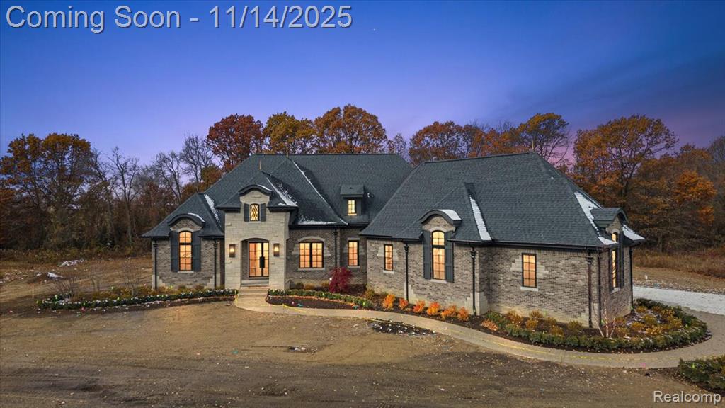 Welcome to an extraordinary opportunity to own a stunning 3,823 sq ft split ranch masterpiece by Lassale Homes, perfectly poised for completion by February 2026. Nestled in the prestigious Vistas of Oakland, this property redefines refined, transitional-style living. As you enter, you are greeted by an open-concept layout that effortlessly blends sophistication with comfort. The great room flows seamlessly into a chef's kitchen adorned with earthy-toned finishes and abundant cabinetry, complemented by high-end included appliances. Elegant wood-cased arches and expansive windows throughout the home ensure a light-filled, inviting ambiance. Step outside to the covered lanai, featuring a cozy outdoor fireplace, an idyllic space for year-round relaxation and entertaining. The private primary suite is a true sanctuary, offering lanai access and a spa-inspired bath complete with floating vanities, a luxurious soaking tub, an oversized shower, and a custom walk-in closet.Accommodating guests with style, a separate guest wing boasts two well-appointed bedrooms with walk-in closets, connected by a stylish dual-entry Jack and Jill bath. A private fourth bedroom upstairs, complete with its own ensuite and walk-in closet, provides the perfect retreat for family or guests. The property also features an oversized 3.5-car garage with tall ceilings and direct access to the lower level. The expansive basement, with impressive 10-foot walls, is ideal for a home gym, recreation space, or golf simulator setup, allowing for endless customization. Additional highlights include a full sprinkler system and included kitchen appliances, showcasing a commitment to quality and convenience. This exceptional home is waiting to make its mark, experience the allure of luxury living in the Vistas of Oakland. Your dream home awaits.