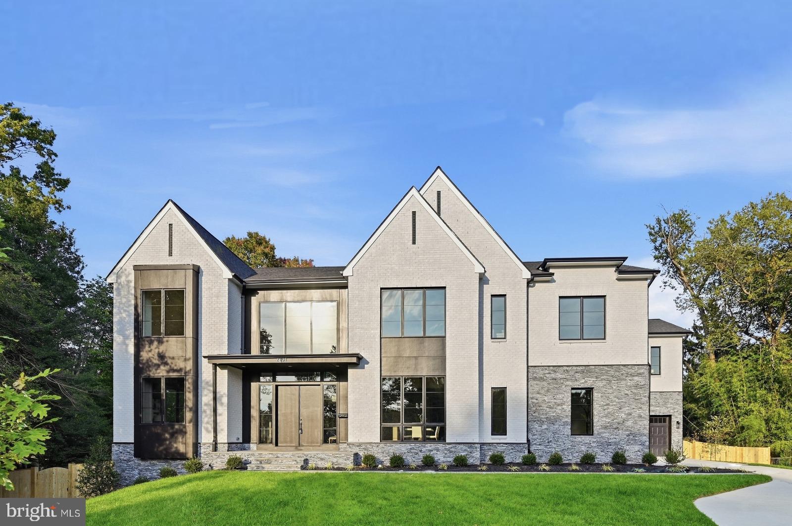 OPEN HOUSE: Sunday, 1–4 PM at 2101 Grayson!  Discover exceptional space and thoughtfully appointed luxury at 2101 Grayson, ideally located in Falls Church just minutes from the West Falls Church Metro and within the sought-after Haycock Elementary, Longfellow Middle, and McLean High School pyramid. Offering over 9,600 square feet of living space, 7 bedrooms, and 7.5 bathrooms, this popular floor plan pairs builder’s model home specifications with generous spaces for everyday living, entertaining, and relaxation.  A dedicated spice kitchen adds versatility for meal preparation and hosting, with optional cabinetry, a garbage disposal, and a dishwasher available to enhance its functionality. Outdoor living is equally inviting, with a screened porch featuring a gas fireplace heater, a deck, and a patio beneath the screened porch providing multiple settings for dining and gathering. An outdoor kitchen offers flexibility for a outdoor cooking area.  The deluxe finished basement brings recreation and retreat together in one expansive level. A professionally designed media room creates the setting for movie nights, while a recreation room and designer wet bar provide an inviting space to entertain. A dedicated gym, sauna, and wine room further elevate the experience. A bedroom with a closet, a full bathroom with a shower, a craft room, and a storage area complete this thoughtfully equipped lower level.  With its impressive scale, extensive amenities, and convenient access to Metro, this Anchor Homes residence offers an exceptional opportunity to enjoy luxury living in a desirable Falls Church location.