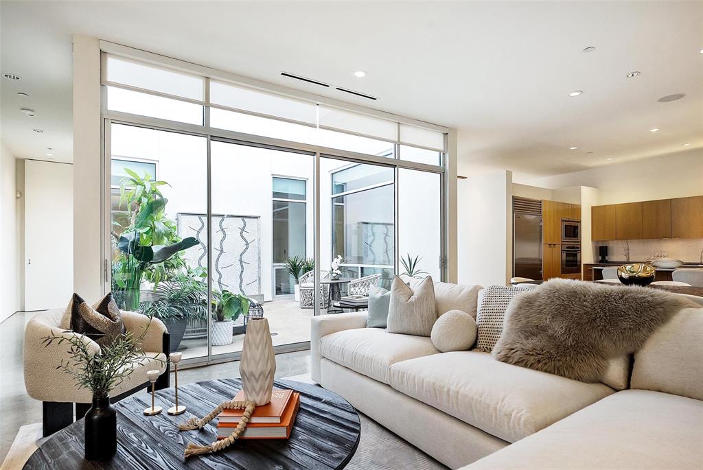 Welcome to Art House Unit 3B, a boutique architectural landmark in the heart of Oak Lawn, where contemporary design, privacy, and city-center convenience converge. With just eight residences, Art House offers a rare combination of exclusivity, elegance, and sculptural living — a sanctuary for those who value both form and lifestyle.Unit 3B, designed by acclaimed architect Lionel Morrison, is a top-floor, treetop retreat centered around a private open-air courtyard. Floor-to-ceiling windows, expansive skylights, and soaring museum-finish walls frame a light-filled, gallery-like interior, while a private courtyard with a tranquil fountain creates a serene indoor-outdoor connection.The sculptural kitchen is as functional as it is elegant, with stainless steel countertops, an oversized breakfast island, and premium Sub-Zero appliances, ideal for hosting intimate gatherings or celebratory dinners.This residence features two refined bedroom suites, two-and-a-half baths, a glass-enclosed office, polished concrete floors, a dedicated utility room, two garage spaces, and private storage — all curated for elevated modern living. Experience the rare opportunity to own a museum-quality, treetop residence in one of Dallas’ most architecturally significant boutique communities, where light, design, and lifestyle unite in perfect harmony.