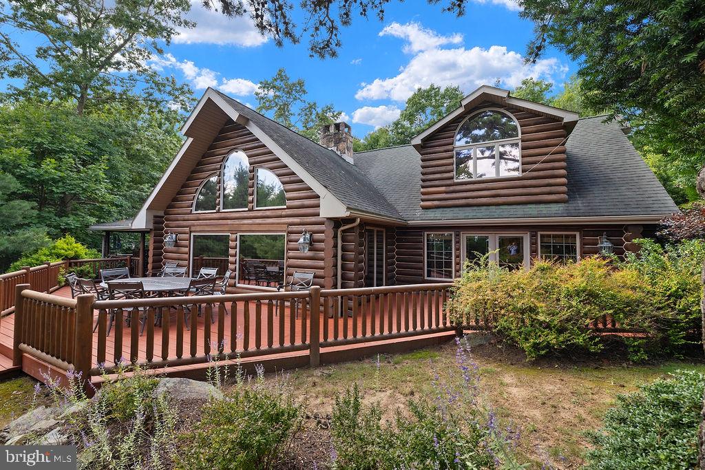 Welcome to a truly one-of-a-kind full-log mountain retreat offering approximately 3,898 sq. ft. of beautifully designed living space on 7 wooded acres along the Piney Ridge mountain line. This exceptional property combines rustic character, thoughtful updates, and resort-style outdoor living with commanding views across Adams County and the surrounding orchard country.The home features three primary suites, each with fully remodeled baths showcasing distinctive, high-end design details. The renovated kitchen is equipped with top-of-the-line appliances and flows naturally into the home's inviting living spaces. The main-level primary suite features French doors opening directly to the deck, creating an effortless connection to the outdoors and amazing views.The lower level adds even more versatility with a sauna, wood-burning stove for supplemental heat, and abundant storage. Heating and cooling, water, and septic systems have all been fully updated, and a whole-house generator provides added peace of mind.Step outside and discover an extraordinary private oasis. The outdoor living area features a stone fireplace, built-in grill, refrigerator, and a wood-fired pizza oven—perfect for entertaining or relaxing while taking in the peaceful mountain setting. A saltwater, free-form inground pool features a dramatic rock waterfall and overlooks the scenic "Narrows Valley." Nature lovers will appreciate the property's abundant wildlife, including deer, wild turkeys, and a wide variety of wild birds. The home is minutes from the Appalachian Trail, Michaux State Forest, and Fuller Lake, offering endless opportunities for hiking, recreation, and exploration.The detached garage is equipped with electricity and plumbing lines ready for the addition of water. The log exterior is professionally stained every 3–4 years, helping preserve the home's distinctive character and beauty.Despite its tranquil, private setting, the property is conveniently located within approximately 20–30 minutes of Chambersburg, Carlisle, and historic Gettysburg. If you're looking for a remarkable mountain home with privacy, views, exceptional outdoor amenities, and a design unlike anything else, this Piney Ridge retreat deserves your attention.