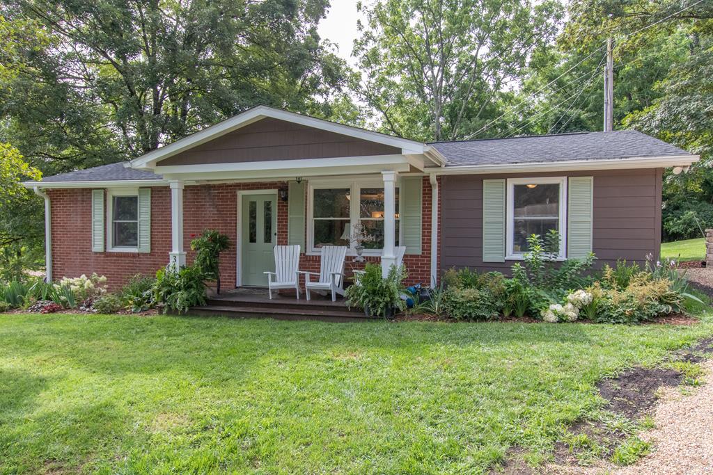 This adorable one level brick house is your perfect new home. This remodeled residence sits on a Cul de sac on a quiet street directly across from the Virginia Creeper Trail head. Talk about an amazing location... It is within steps of historic downtown Abingdon Farmer's market, Amazing Restaurants and Barter Theatre just to name a few. As you enter the home, you will see an open floorplan with living room and kitchen combined. The gray walls throughout bring a certain calm to the floorplan along with original hardwood floors. The cream cabinets are accented with brown quartz countertops, subway tile and stainless steel appliances. This is a very spacious and workable kitchen with an electric stove, two ovens as well as a convection option. Off the kitchen is a patio to enjoy your morning coffee and also has room for a grill. To the left are two bedrooms with large closets in each room. The laundry room is off that hallway. A large bath has double bowl sinks, a tub and shower combo. To the right of the great room is the master suite with a walk in closet, tiled shower, tiled heated floors and great views of the outdoors. The outdoor mature landscaping is full of hydrangea and a kaleidoscope of seasonal color. Additional outdoor space includes a front porch and a newly finished parking area and stone retaining wall.