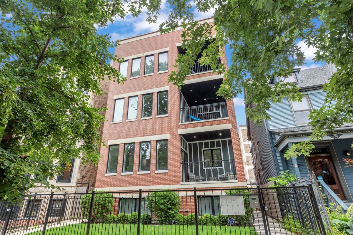 Welcome to Unit 1E, built on an exceptional 37.5-foot lot allowing for an extra-wide floorplan. This stunning duplex-down condo features an open-concept main level with beautiful 3.25" White Oak flooring throughout. The gourmet kitchen showcases premium SubZero, Wolf, and Bosch appliances with a large island for entertaining and elegant 2.5" quartz countertops. Separate living and dining areas include a cozy gas fireplace, while the private balcony offers a gas line for outdoor entertaining, plus there is an additional rear patio space with a private yard.  The lower level provides a private sanctuary with radiant heated floors throughout three generously sized bedrooms and two full bathrooms. Porcelain tile flooring spans the common areas with plush carpet in bedrooms. The primary suite features double closets and a spa-like ensuite with dual vanity, rain shower, and handheld body sprayer. The second bathroom includes a deep soaking tub with shower combo. Additional amenities include a dedicated laundry room with storage and one included garage parking spot.  This exceptional home combines sophisticated luxury finishes with thoughtful design and practical living features, creating the perfect move-in ready sanctuary.