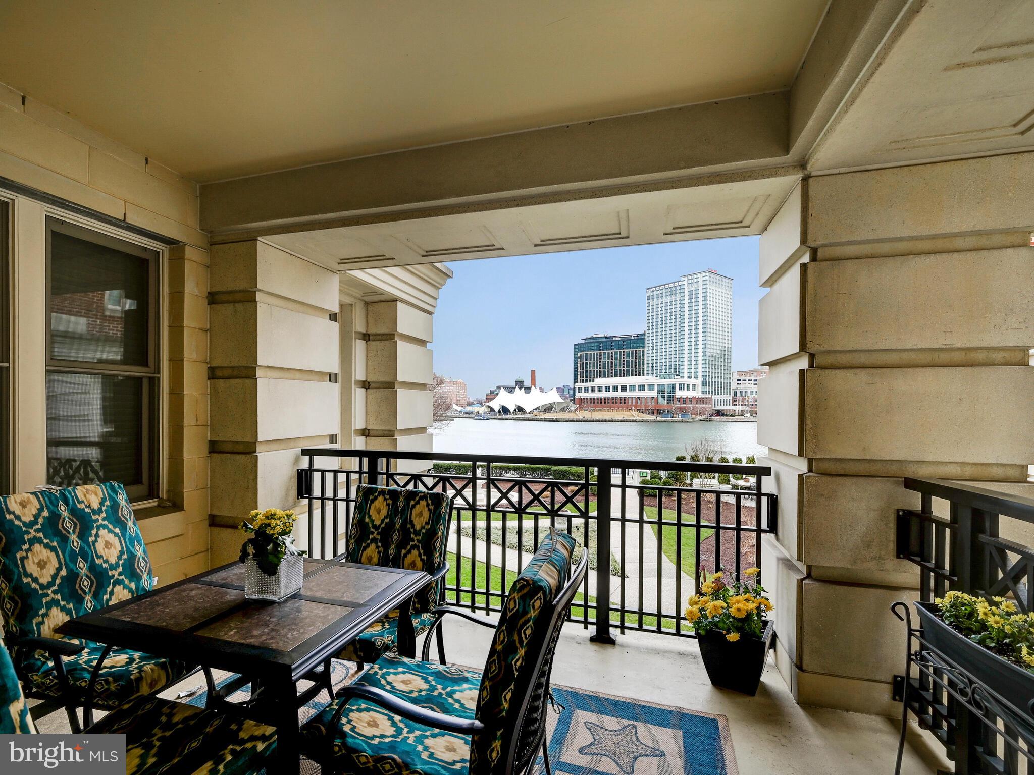 Enjoy stunning harbor views from this gorgeous two bedroom, one full and one-half bathroom, 1600 square foot, waterfront residence with two deeded parking spaces at The Ritz-Carlton Residences. Ideally located, residence 222 sits directly over a private garden with a beautiful fountain and has direct views of the water and Inner Harbor from every living space. Park in the gated and conditioned garage, step into your semi-private elevator, and into your private vestibule/foyer. The incredible open layout has the feel of one large room with the flexibility to separate the space into a living room and den/separate dining area/office/bedroom. The living room is centered around a handsome gas fireplace and is highlighted by crown molding and a wood frame sliding door out to the spacious balcony perfect for morning coffee or evening dinners. The gourmet kitchen opens into the living room and offers designer shaker cabinets accented by the lighted backsplash, kitchen bar seating, granite countertops, and stainless-steel Viking appliances. The highly flexible second bedroom/den/dining area/office space is currently being used as a separate dining room/office and can be left open to the rest of the living space or closed off by two custom designed glass-panel doors. The butler pantry offers a full laundry space with sink and extra storage and allows for private delivery from The Ritz-Carlton porter team from the service hallway. The primary bedroom suite has two closets including a large walk-in, crown molding, and incredible views of the Inner Harbor. The connected primary bath has two separate vanities, a large soaking jacuzzi tub, private water closet, and a luxurious standup shower. A deeded storage space and a private HVAC closet off of the service hallway are also included. 5 Star Living at The Ritz-Carlton Residences includes the famous 24-hour concierge service, complementary valet for owners and guests, porter service, doorman, 24/7 security, cleaning service, and more. The newly updated community amenities are second to none in the harbor and include 6 acres of garden area, a private 24-person movie theater, Game and Billiard Room, Board Room, Residence Lounge, No Excuses Fitness Center, Indoor Saltwater Pool connected to the Meditation Garden, Six Guest Suites, access to the Art of Balance Wellness Spa, a highly acclaimed soon to be unveiled restaurant with room service, and much more!