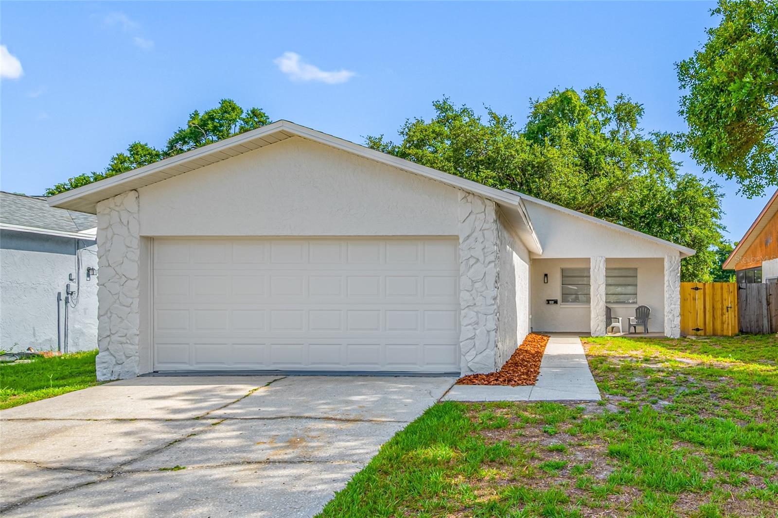 Thoughtfully Updated 2-Bedroom, 2-Bath Home With A 2-Car Garage In The Heart Of Pinellas Park. Major Improvements Include A New Roof (2026), Newer HVAC System (2022), New Water Heater (2026), Fresh Interior And Exterior Paint, And New Fixtures Throughout. The Well-Designed Floor Plan Features A Separate Living Room, A Dining Area With A Breakfast Bar Overlooking The Kitchen, And Laminate Flooring Throughout Most Of The Home, With Tile Flooring In Both Bathrooms. The Kitchen Offers White Shaker Cabinetry, Granite Countertops, A Tile Backsplash, Recessed Lighting, And Stainless Steel Appliances. The Primary Bathroom Features A Tiled Walk-In Shower With A Built-In Seat, While The Guest Bathroom Includes A Tub/Shower Combination. The Attached Two-Car Garage Houses The Laundry Area And Provides Additional Storage. Step Outside To Enjoy The Covered Front Porch And The Spacious, Fully Fenced Backyard, Where A Mature Oak Tree Provides Shade And Creates A Beautiful Setting For Relaxing Or Entertaining. Conveniently Located Just Minutes From The Shoppes At Park Place, You'll Enjoy Easy Access To Shopping, A Wide Variety Of Restaurants, And Everyday Conveniences. Schedule Your Private Showing Today And Discover Everything This Thoughtfully Updated Pinellas Park Home Has To Offer. Cash, Conventional, And VA Financing Welcome.