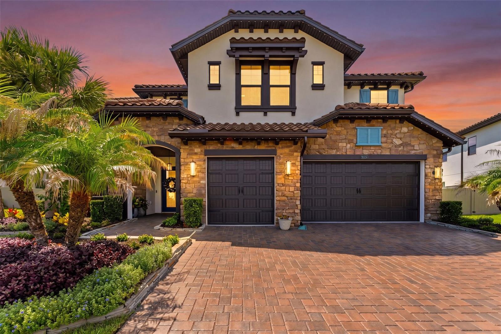 Under contract-accepting backup offers. Welcome to this 5-bedroom, 5-bathroom home nestled in the gated community of Estancia at Wiregrass in Wesley Chapel! This home is 4,588 sq ft thoughtfully designed across two floors with soaring high ceilings & crown molding throughout.  The open layout flows seamlessly into a spacious family room with views of the backyard oasis featuring a heated saltwater pool and spa — all surrounded by mature, wooded landscaping with a trees/woods view. Additional highlights include a 3-car garage with a built in car lift, lighted soffit feature all located on an oversized 0.28-acre lot. The Estancia community amenities are second to none — enjoy a clubhouse, resort-style pool, playground, fitness center,  gated security, and recreation facilities. Zoned for top-rated Wiregrass Elementary, John Long Middle, and Wiregrass Ranch High School. Conveniently located just minutes from I-75, premium shopping, dining, and medical facilities.