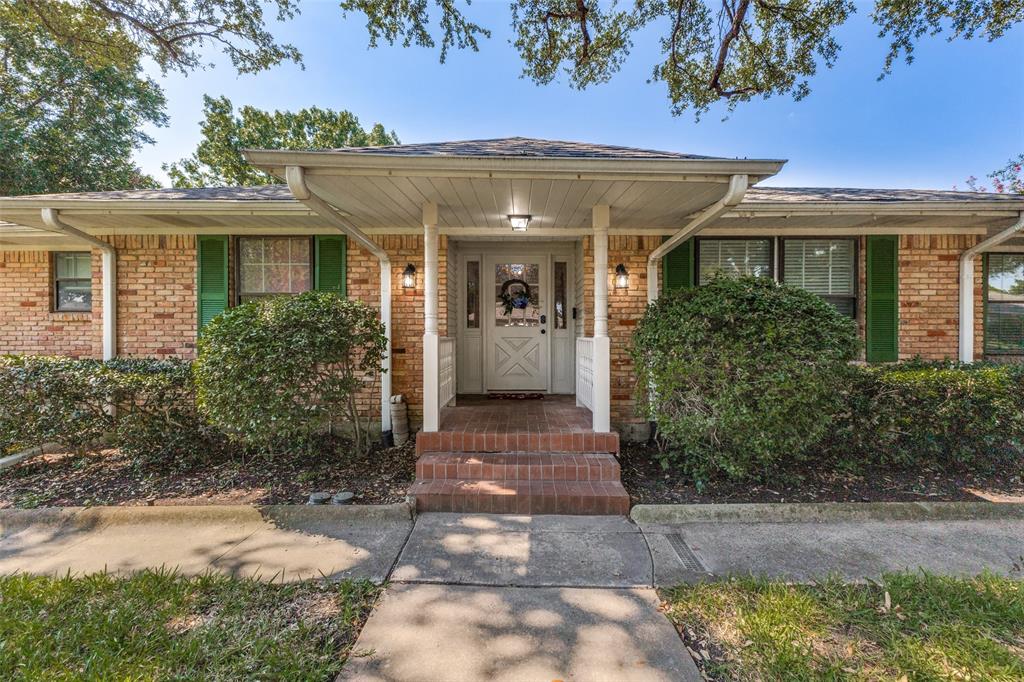 Welcome to a true Mid-Century Modern gem nestled on a spacious, shady lot in one of the area's most sought-after neighborhoods! Located within walking & biking distance to schools, churches, shopping & entertainment, this home offers both style and convenience. From the moment you arrive, you’ll be captivated by the majestic shade tree & welcoming front porch—a perfect spot to relax and connect with neighbors. Step inside to an expansive foyer adorned with original travertine tile, setting the tone for the thoughtful design & preserved architectural details found throughout. Just off the entry, a flexible formal space—currently a game room with billiards table—can serve as elegant living & dining areas. The inviting family room is anchored by a stunning, wall-to-wall brick fireplace with new gas logs, creating a dramatic focal point. The renovated kitchen is a tasteful blend of timeless & modern: Turkish bullnosed granite countertops, rich cabinetry, slate flooring, stainless steel appliances, pantry & sunny breakfast nook. Adjacent, a full-size laundry room with half bath add practicality to the charm of this space. Retreat to the spacious primary suite, large enough for a king-sized bed, with generous closet space & private access to the enclosed rear porch. The ensuite bath has been beautifully updated while honoring the home’s roots. Three additional bedrooms provide flexible living, office, or guest space. Throughout the home, you'll find original hardwood flooring, vintage tile & fixtures, beautiful molding & authentic ceiling treatments that showcase true MCM craftsmanship. Step outside to your own backyard oasis—perfect for gardening, pets or play. Don’t miss the incredible detached workshop featuring concrete foundation, screened-in porch, 110 & 220V electric, built-in workbench and shelving—ideal for hobbyists, crafters, or creative kids! This home is the Mid-Mod dream you've been waiting for—filled with character, updates, and one-of-a-kind charm.