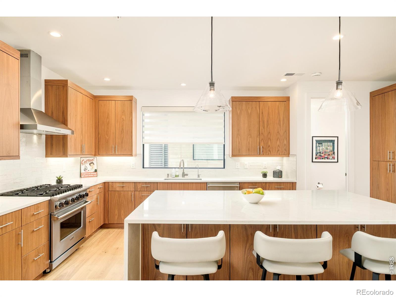 Jaw-dropping Flatiron views, completed in 2021, a coveted end-unit location widely considered one of the best in Walnut Crossing, & one of the few HOAs in Boulder that does not prohibit short-term rentals make this exceptional townhome a rare opportunity. Perfect as a luxury lock-&-leave residence, second home, or flexible investment. Ideally located across from the Dairy Arts Center, enjoy front-row access to Boulder's thriving arts scene & unparalleled convenience during the renowned Sundance Film Festival. Designed with impeccable finishes throughout, the open-concept floor plan features wide-plank white oak wood floors, smooth drywall finish, solid-core doors, Pella windows & gas fireplace. The chef's kitchen boasts Viking appliances & dual-zone wine refrigerator, custom walnut cabinetry & an oversized waterfall-edge quartz island. Retreat to the luxurious primary suite featuring a spa-inspired bath w/heated floors, a soaking tub, dual shower heads & enhanced comfort from an owner-upgraded dedicated mini-split heating & cooling system. Take in breathtaking Flatiron views from the spectacular rooftop deck w/built-in BBQ w/granite counters, the living room deck or the covered front porch w/private fenced yard. Enjoy upgraded sound insulation between floors, custom steel balcony railings, hose bibs on every balcony, ADT security, secured parking, individual water meter & basement crawl space storage area w/direct access from the carport rarely found in townhomes. Additional owner upgrades include Hunter Douglas top-down/bottom-up honeycomb blinds, blackout shades, ceiling fans, whole-house steam humidifier, Ecobee smart thermostats, Wi-Fi-enabled Schlage locks, Multi-Pure carbon block kitchen water filtration, filtered shower heads, carpet stair runners, & a recently replaced electric water heater. Luxury finishes, incredible views, exceptional flexibility, & an unbeatable central Boulder location combine to create one of the most desirable townhomes on the market!