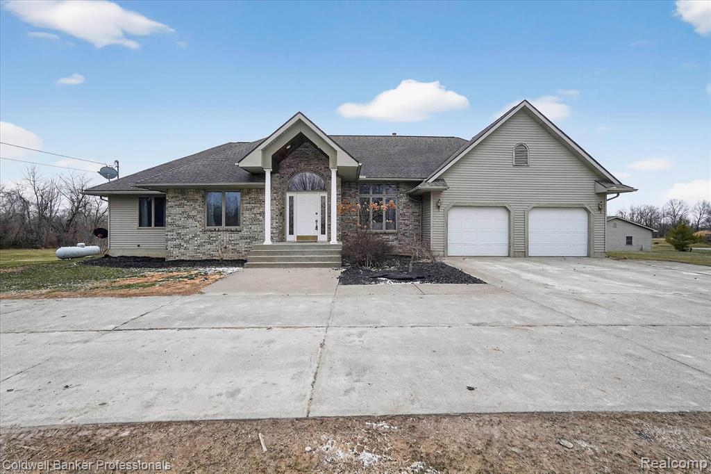 One-of-a-kind ranch on over 8 private acres in the Lake Fenton School District! This beautifully updated home blends modern comfort with peaceful country living. The open, light-filled layout features soaring ceilings, recessed lighting, LifeProof flooring, and a cozy gas fireplace. The stunning kitchen is the heart of the home—showcasing quartz countertops, a large center island, new stainless appliances, custom cabinetry, and easy access to first-floor laundry. The luxurious primary suite feels like a retreat with private deck access, walk-in closet, and a spa-style bath featuring a Jacuzzi tub and separate walk-in shower. Two additional bedrooms and 1.5 baths complete the main level.The finished walkout basement includes a second living area with a wood-burning fireplace, two non-conforming bedrooms, a full bath, and generous storage. Outside, enjoy over 8 acres across two parcels with fruit trees and abundant wildlife. A 3-car attached garage plus a 4-car detached garage provide the perfect setup for projects, toys, or extra vehicles. Space, privacy, and stunning features—this property truly has it all!