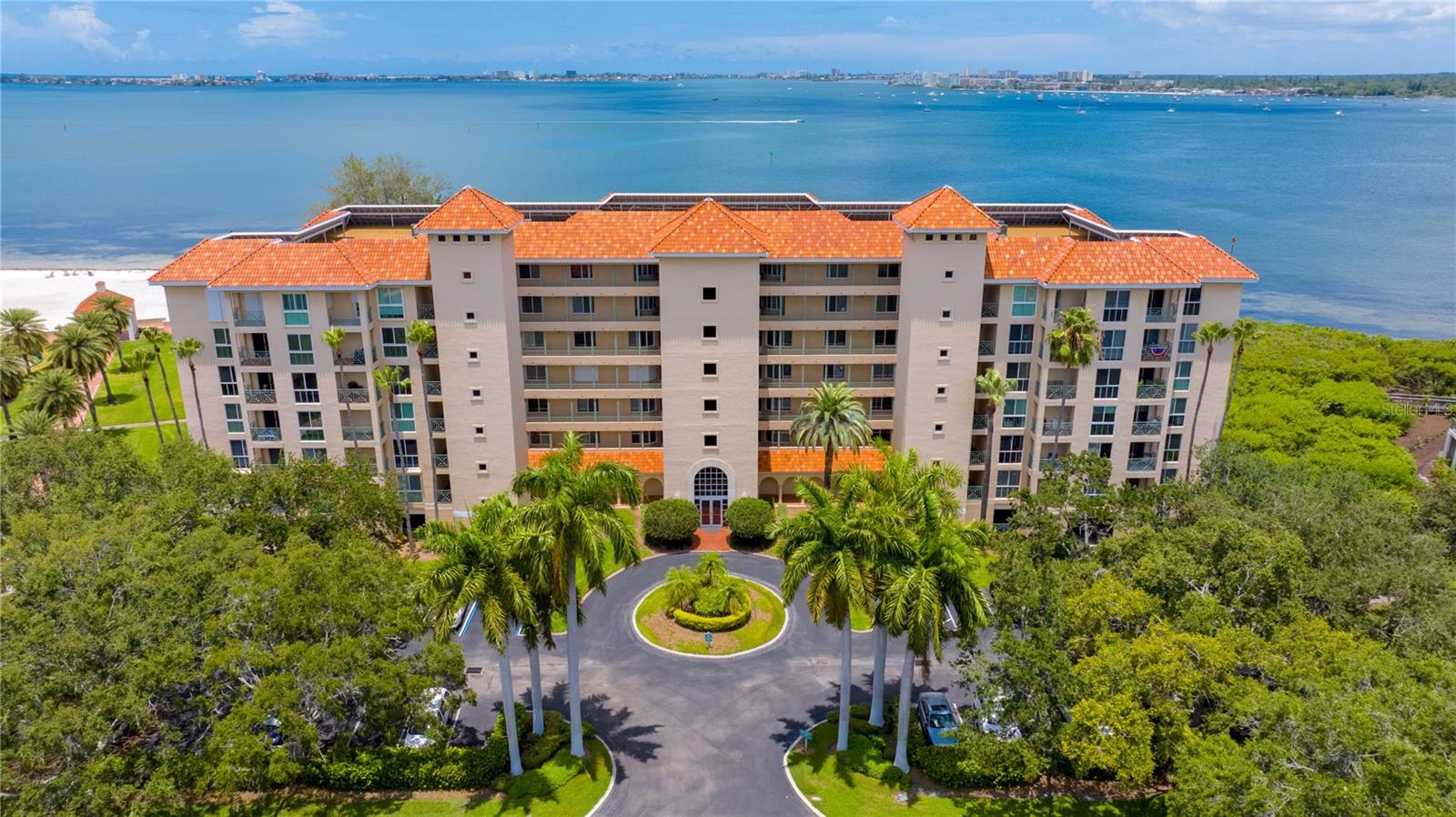 Experience refined waterfront living in this exceptional corner residence at Dolphin Cay, a guard-gated coastal community along Boca Ciega Bay. Open-water views and year-round sunsets set the stage from an expansive 900-square-foot wraparound deck, a true extension of the living space for outdoor dining, entertaining, and every day enjoyment of Florida’s waterfront lifestyle.Inside, walls of windows fill the open-concept layout with natural light. The chef’s kitchen anchors the home with generous storage and a functional design that flows into the living and dining areas, suited to both quiet evenings and elegant gatherings. A versatile bonus room, ideal as a den, office, or potential third bedroom, accesses the amazing outdoor deck through tall sliding glass doors showcasing the stunning views of the iconic Don Cesar Hotel, and beach pool and private beach areas.  The owner’s suite is a private retreat with a spacious walk-in closet, and a spa-inspired bath. Guest quarters are positioned for privacy, with an adjacent bath and laundry area.Additional features include a reserved under-building parking space and a private storage room at the condo entrance. Hurricane shutters add protection and peace of mind. The well-maintained building has completed its Milestone inspection and Structural Integrity Reserve Study (SIRS).Dolphin Cay’s 88 acres of lush, gated grounds offer a resort-style setting with a private beach on Boca Ciega Bay, kayak launch, fishing pier, three heated pools, three lighted Har-Tru tennis courts, fitness center, library, clubhouse with billiard room, and scenic walking trails. Downtown St. Petersburg’s arts scene, dining, and waterfront venues are minutes away, as are the sugar-sand beaches of St. Pete Beach and Pass-a-Grille. Both Tampa International and St. Pete-Clearwater International Airports are easily within 35 minutes.A rare opportunity to own a corner waterfront residence with over 900 feet of expansive outdoor living and sweeping sunset views,  A true example of living the Florida lifestyle at its finest!