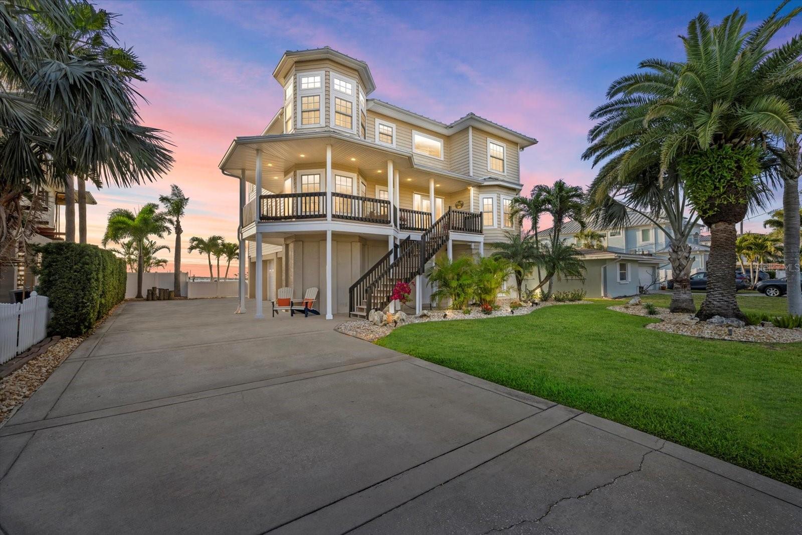 Discover breathtaking sunsets from this custom 4-bedroom, 4-bath Dunedin retreat on St. Joseph’s Sound. A paradise for fishing, boating, and beach enthusiasts. Enjoy west-facing open water views, a 20,000+ gallon pool and spa, and multi-level composite decks designed for effortless outdoor living. The private deep-water dock features boat and watercraft lifts on direct Gulf access, with snook, trout, and baitfish right off the dock, plus nearby fueling stations, ramps, and marine services to keep your adventures going.

Inside, find a bright two-story foyer, remodeled bathrooms, impact windows and doors, and a spacious family room with panoramic water views and a cozy fireplace. Entertain effortlessly with newer stainless steel appliances and a dumbwaiter in the kitchen. This home features a beautiful master bedroom with three spacious additional bedrooms all with large closets and custom organizers. The four beautifully remodeled bathrooms — including a convenient bonus half bath on the ground level — ensures both style and practicality throughout.

Thoughtful upgrades enhance every corner of this property, inside and out. You’ll find rich wood floors throughout, custom wood plantation shutters, and a brand-new metal roof with updated soffits and gutters. Designed to offer something for everyone, the home includes impact-rated windows and doors, a 16,000lb boat and jet ski lift, and a generous 1,500+ sqft three-car garage (with room for a full-size truck) plus extra storage for all your boating, beach, and entertaining essentials. Enjoy direct access to the gulf and island beaches with intercostal protection from Caladesi and Honeymoon island in your backyard. The prime location is minutes from beaches, the dining and breweries of Dunedin main street, and the Pinellas Trail. Live the ultimate waterfront lifestyle — sunsets included!