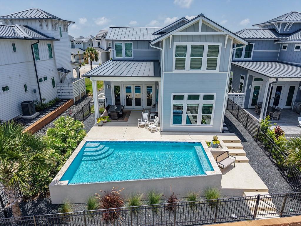 Your waterfront escape: 4 bedrooms, a stunning plunge pool, private dock, and an oversized boat garage. This like-new home offers a highly desirable floor plan with the primary suite downstairs, an oversized boat storage garage with a 12ft garage door and depth of 29ft, plus an electric car charging port and plumbing for an ice machine. The east-facing rear orientation provides perfect afternoon shade by the pool overlooking the canal. Inside, the open-concept kitchen, dining, and living area features neutral colors, ideal for any style, along with a gourmet kitchen complete with stainless steel appliances, a gas Bertazzoni range, beverage fridge, and more. The downstairs primary suite includes a luxurious ensuite bathroom with a walk-in shower. Upstairs, you'll find a spacious flex space, perfect for a secondary living area or home office, as well as three guest bedrooms and two additional baths, providing plenty of room for hosting family and friends. Outdoor living is exceptional with a private dock ready for your boat, an outdoor shower to rinse off after a day on the water, and a private pool that makes every day feel like a vacation. Located in a gated community with $2M+ in amenities including a 2+ mile walking path, a pier, pool, and hammock park. HOA dues cover on-site staff, lawn care, and more, making ownership low maintenance and easy. This property offers the ultimate blend of coastal charm and modern luxury—ready for you to enjoy as a primary residence, weekend retreat, or investment opportunity.