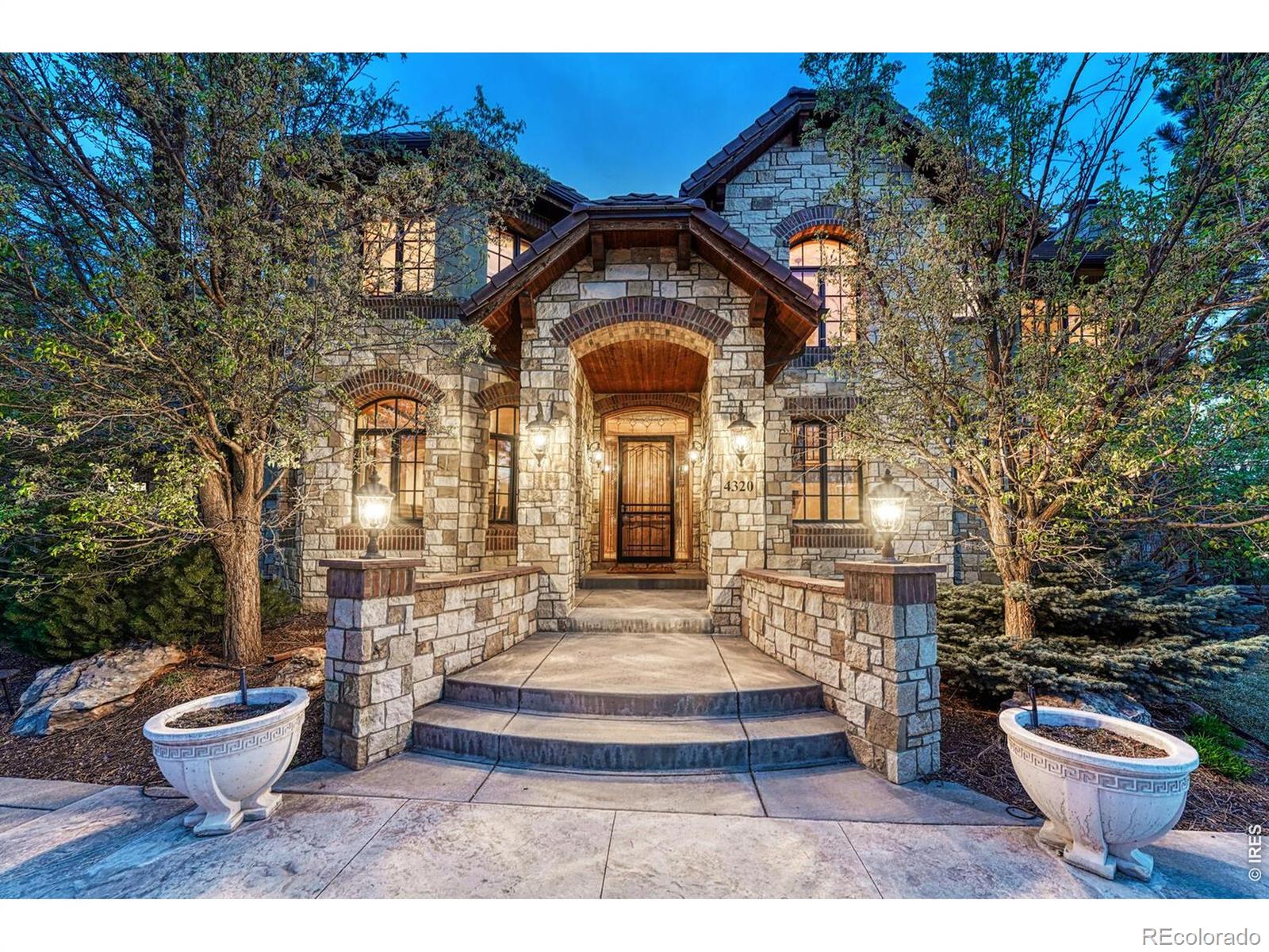 Tucked within the prestigious and highly sought-after enclave of The Preserve, this extraordinary estate offers a rare blend of privacy, scale, and refined elegance. Perfectly positioned on a secluded corner lot spanning just shy of three-quarters of an acre, the property is surrounded by mature trees, creating a serene, park-like setting-an increasingly rare find in today's luxury market. A grand circular driveway welcomes you with timeless sophistication, setting the tone for the residence beyond. Inside, the home offers six spacious bedrooms and seven beautifully appointed bathrooms, thoughtfully designed for both comfort and privacy. The upper level features four bedrooms, each with its own en suite bathroom, including a luxurious primary retreat complete with a private balcony and mountain views. Designed for both everyday living and elevated entertaining, the home showcases a chef's kitchen with high-end finishes and premium appliances, seamlessly flowing into the main living spaces. Just off the butler's pantry, a temperature-controlled wine cellar provides the perfect space to showcase an impressive collection. The lower level enhances the home's versatility with a two generous recreation rooms, a full bar, and two additional bedrooms-ideal for guests or a private retreat. The backyard is equally impressive, featuring a covered patio, built-in outdoor kitchen, and a striking fireplace that creates a warm, inviting atmosphere year-round. Backing directly to a scenic path that connects to the Highline Canal, this home offers immediate access to one of Colorado's most treasured outdoor corridors, with over 70 miles of trails winding through the Denver metro area allowing for walking, biking and outdoor recreation. This is more than a home-it's a lifestyle defined by tranquility, exclusivity, and connection to nature in one of the area's most coveted communities.