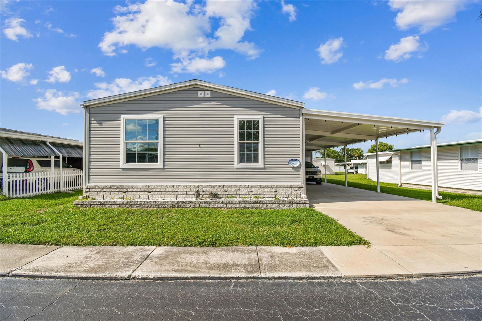 Stunning 3-Bedroom 2017 Manufactured Home in the Pointe West 55+ Community – Coastal Vibes with Designer Touches makes this Furnished home MOVE IN READY!
Step into this light and bright 3-bedroom, 2-bath manufactured home that perfectly blends style, comfort, and functionality. From the moment you enter, you’ll notice the high ceilings, crown molding, chair rail, and custom lighting that add an elegant touch throughout.
The spacious ktchen is a true centerpiece with tons of counter space, abundant cabinetry, and a cozy nook ideal for a crafting area or home office. An inside laundry room adds convenience, while the showstopper dining area features a custom table and high-end designer furnishings that make entertaining effortless.
Enjoy the coastal, Key West-inspired vibe in the bedrooms, designed with comfort and charm in mind. The primary bedroom has an ensuite bathroom with walk in shower and double vanity.  The Tommy Bahama inspired furniture in this bedroom is just another added feature that adds the impressive furnishings throughout. 
Outdoors, the home boasts an impressive 16 ft wide, 3-car carport with golf cart parking, plus an oversized storage area with double doors—perfect for motorcycles, golf carts, or workshop space. 
Located in a welcoming 55+ community, you’ll enjoy resort-style living with amenities, social events, and the relaxed Florida lifestyle you’ve been dreaming of. So Get Ready The Beach is Calling.. Just minutes to our Sugar Sand Beaches, Dining, Lake Seminole, and so much more. Affordable Florida Living at $300 month including Water, Trash, LawnCare and all the amenties... including private access to Lake Seminole.