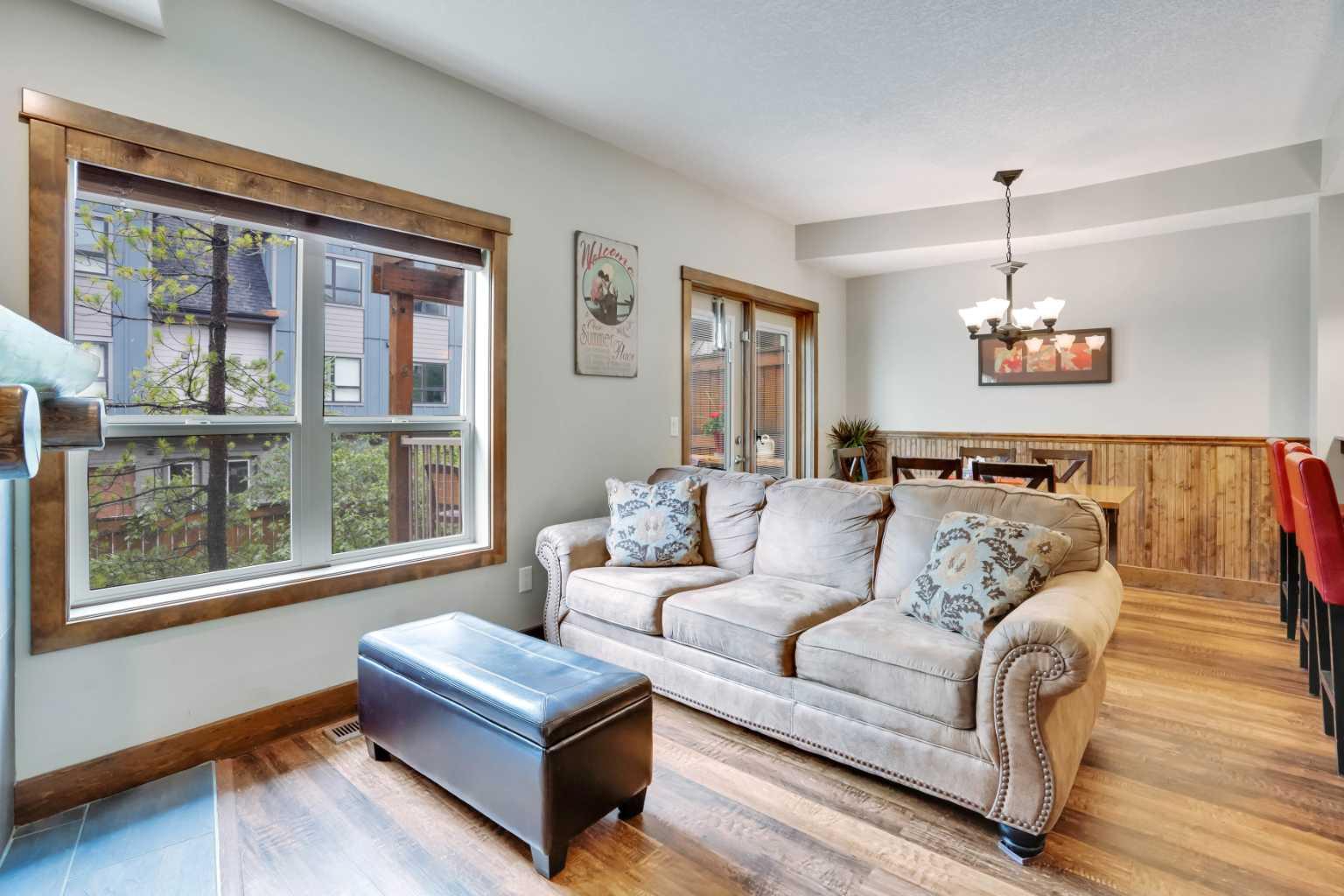 Enjoy the warm afternoon sun from one of 2 SW patio’s surrounded by attractive mountain architecture and beautiful views of the Mt. Rundle! This is one of the most peaceful and quiet locations you will find! This spacious 2 story townhouse has direct access to your vehicle for easy unloading of all of your gear & groceries! The entry level has a cozy living area, bright dining area with fully equipped kitchen and half bath. The doors and trim throughout are solid pine and the most of the flooring has been recently upgraded to match the warm mountain feel of the decor. Downstairs there are 2 large bedrooms each with their own ensuite and own direct outside access. The larger ensuite has been upgraded. The 18 foot long bedroom has the space to include an additional twin bunk which would expand the sleeping to 8-9 people (similar to most 3 bedrooms)! With this upgrade, Income should be strong and part way between a 2 bedroom and 3 bedroom! There is ample storage space both within the unit and in the external storage locker conveniently located beside the entrance door. Amenities include a hot tub & fitness room only a 10 second walk away. Fire Mountain Lodge has a healthy reserve fund and relatively low condo fee which includes air conditioning and in floor heating on the lower level. The location is ideal just a short walk away from the shops of Canmore and Spring Creek. List Price is $919,000+GST. GST is often deferred and not paid at the time of sale when the buyer is GST registered. All furniture, furnishings, kitchenware and unit items are included in the sale. This is a fantastic opportunity to own property & generate strong income on Airbnb!