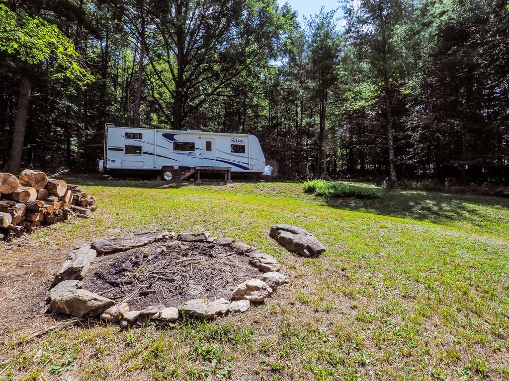Come and find yourself on this peaceful and secluded 4.29 +/- acres with a small stream running through the property! Just off of a state-maintained road you'll find this gem of unrestricted mostly wooded land with a gated entrance, a gravel driveway, and a 27-foot 2008 Holiday Rambler that sleeps 8!  This would be a wonderful place for family getaways, hunting trips, or a place to build your forever home! Public water and power are available and a perc test has been completed. You'll be ready to get things fired up quickly with the remote start  generator that is included with the property! Located just minutes from Hwy 100, I-77, and I-81, this property holds so much potential for a wonderful place to unwind in the Blue Ridge Mountains! Wait no longer, come and take a look!