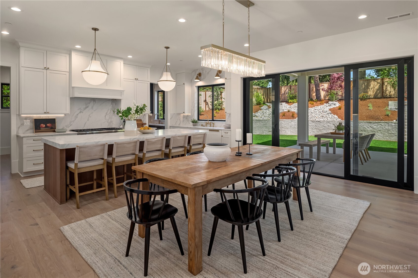 Dining table sits steps from oversized kitchen island