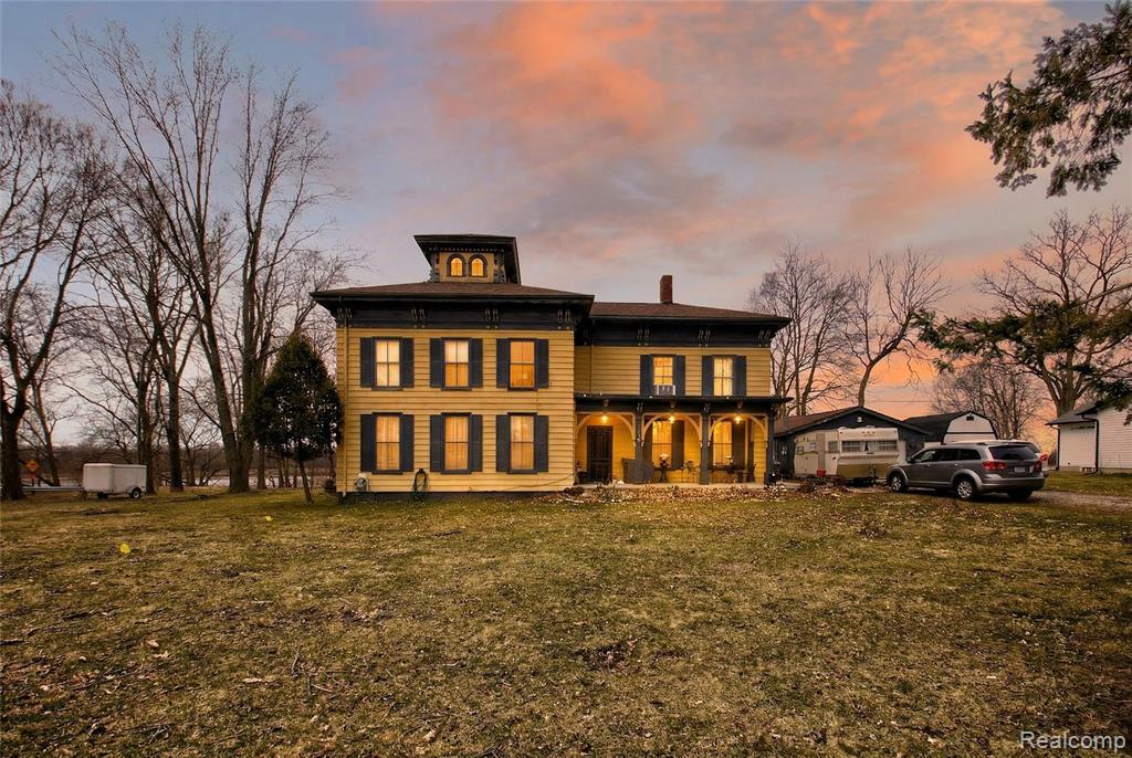 Own a piece of Columbiaville village history! This gorgeous historic home sits on 166 feet of waterfront, adjacent to Holloway Reservoir, on the site of the Niver Brothers Sawmill. The home features a stunning exterior, with even more beauty inside. 4 large bedrooms, 2 full baths, and more space than you'll know what to do with! The main floor holds an enormous eat-in kitchen, with tons of storage and enough space for everyone to gather around, along with a good sized living room with a wall of built in cabinets, perfect for showcasing memories and knick-knacks. The cabinetry really adds to the history beauty of the home. Also on the main floor are a full bath, another room perfect for an office or sitting room, and a dedicated laundry room. The second floor holds three large bedrooms, each with the same rustic touches you'll find throughout the home, along with another office or bonus room, a full bath, a full wet bar, and a family room with a fireplace, perfect for cozy  gatherings. The third floor of the home features a lounge area with gorgeous domed windows, offering breathtaking views over Holloway. Enjoy plenty of outdoor storage with the shed and outbuilding. Newer furnace and hot water heater. You don't want to miss out on this opportunity, schedule your private showing today!