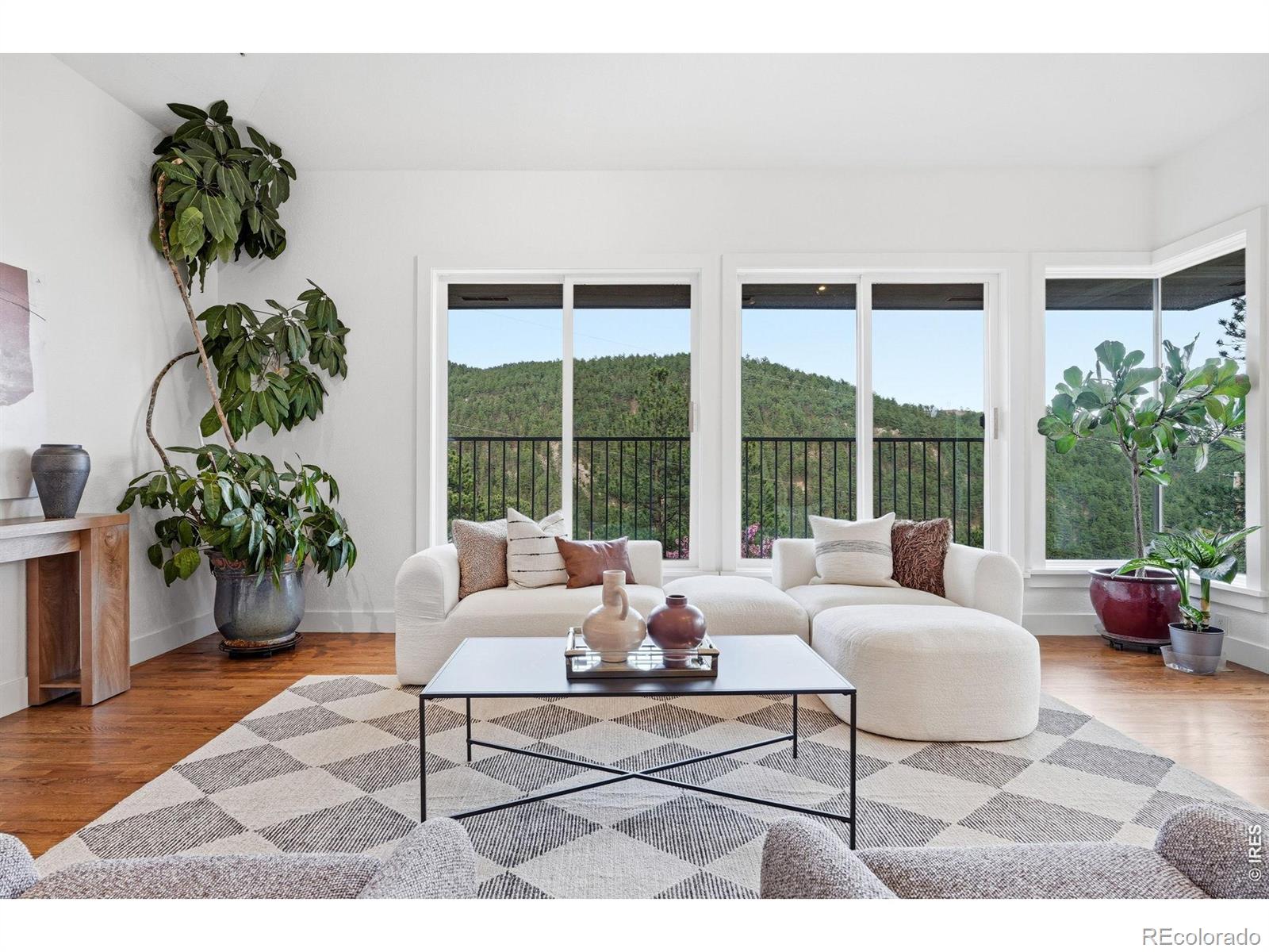 Step inside to a warm, inviting entry that opens into a bright living room anchored by a cozy fireplace and expansive windows framing serene mountain views, along with beautiful city views of Boulder and stunning morning sunrises. A short flight of stairs leads to a charming second sitting area-perfect for morning coffee or evening cocktails, and easily suited for an intimate dining space. The updated kitchen features a large island and flows seamlessly into another living and dining area, where oversized windows continue to capture both mountain and city views from every window. Patio doors open to one of several outdoor spaces, blending indoor and outdoor living. A third main-floor living area, currently used as a TV/lounge, features a wood-burning fireplace and offers flexibility as a home office, library, or additional retreat. Upstairs, a versatile loft complements two secondary bedrooms connected by a Jack-and-Jill bath. The primary suite is a true retreat with sweeping views, a brand-new ensuite bath with soaking tub and dual sinks, and a spacious walk-in closet. Enjoy multiple decks and patios designed to take in the surroundings, along with a hot tub and built-in sauna- perfect for relaxing. A three-car garage completes this exceptional home that is 7 minutes to the Pearl Street mall or walking distance to Lions Lair trailhead.