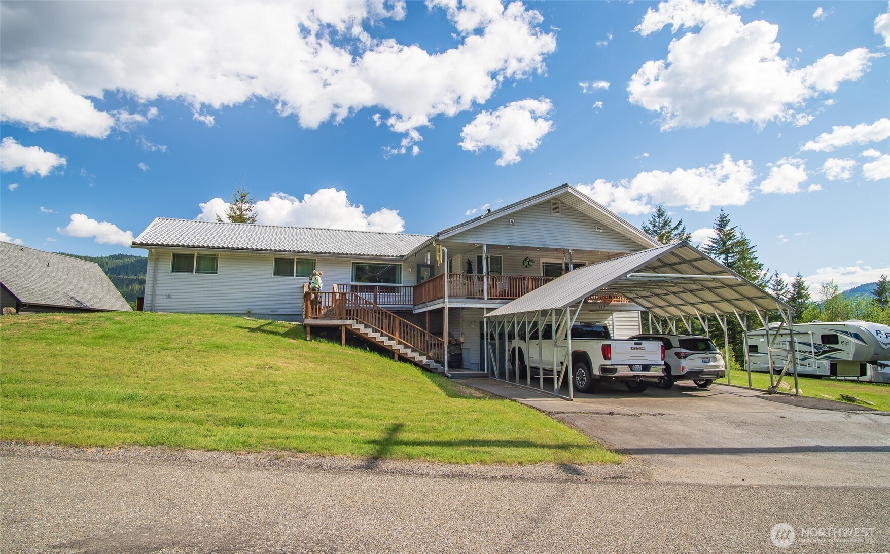 Perched above Packwood with sweeping mountain and town views, this property offers the space and flexibility to truly make it your own. Set on a .85 acre double lot offering space for growth, the 2,068 square foot home was remodeled in 2019 with updated flooring, paint, and bathrooms, plus a brand new heat pump installed in 2026. Large Milgard windows invite in natural light and capture the surrounding landscape, while the Trex deck creates an easy extension of your living space outdoors. An in home elevator provides seamless access from the oversized garage to the main level. With RV parking, a detached carport, and easy access to Mt Rainier, White Pass, and the Cowlitz River, this is Packwood living with both comfort and opportunity.