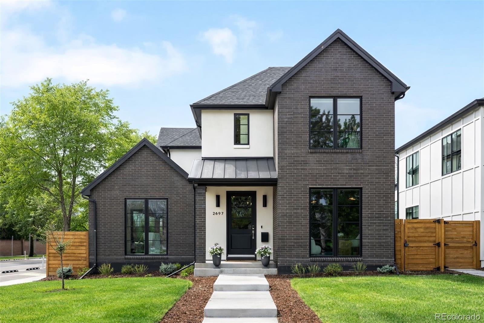 Built by Smith & Meade in 2024, this exceptional Observatory Park residence blends modern architecture with elevated design, thoughtfully crafted for both everyday living and effortless entertaining. A light-filled interior features soaring ceilings, wide-plank hardwood floors, and a seamless connection between indoor and outdoor spaces. At the heart of the home, the chef’s kitchen impresses with premium Thermador and Energy Star appliances, a dual fuel range, an expansive island, a walk-in pantry, and a fully equipped back kitchen featuring an additional oven and a built-in beverage tap system. The adjacent dining area opens through sliding doors to a private backyard, creating an ideal setting for indoor-outdoor living. The living room is anchored by a sleek fireplace and enhanced by custom smart shades. A main-level office and mud room with built-ins provide everyday functionality and access to the EV-ready three-car garage. The main floor primary suite is a serene retreat with a spa-inspired bath featuring a soaking tub, glass-enclosed shower, and a generous walk-in closet, along with a dedicated laundry area. Upstairs, three en-suite bedrooms provide comfort and privacy, along with a full laundry room complete with a utility sink. The finished lower level includes a spacious rec room with a wet bar, media room, two additional bedrooms, and a private gym. Custom cabinetry is thoughtfully integrated throughout the home, featuring pull-out drawers and built-in shelving and dividers that enhance both function and design. Designed for comfort and efficiency, the home includes an Energy Recovery Ventilator, two-stage variable speed furnace and A/C, tankless water heater with recirculation, and whole-home water purification system. Ideally located across from E. Harvard Gulch Trail and moments from McWilliams and Observatory Parks, with easy access to the University of Denver, Wellshire Golf Course, Colorado Boulevard dining, I-25, downtown Denver, and the mountains.