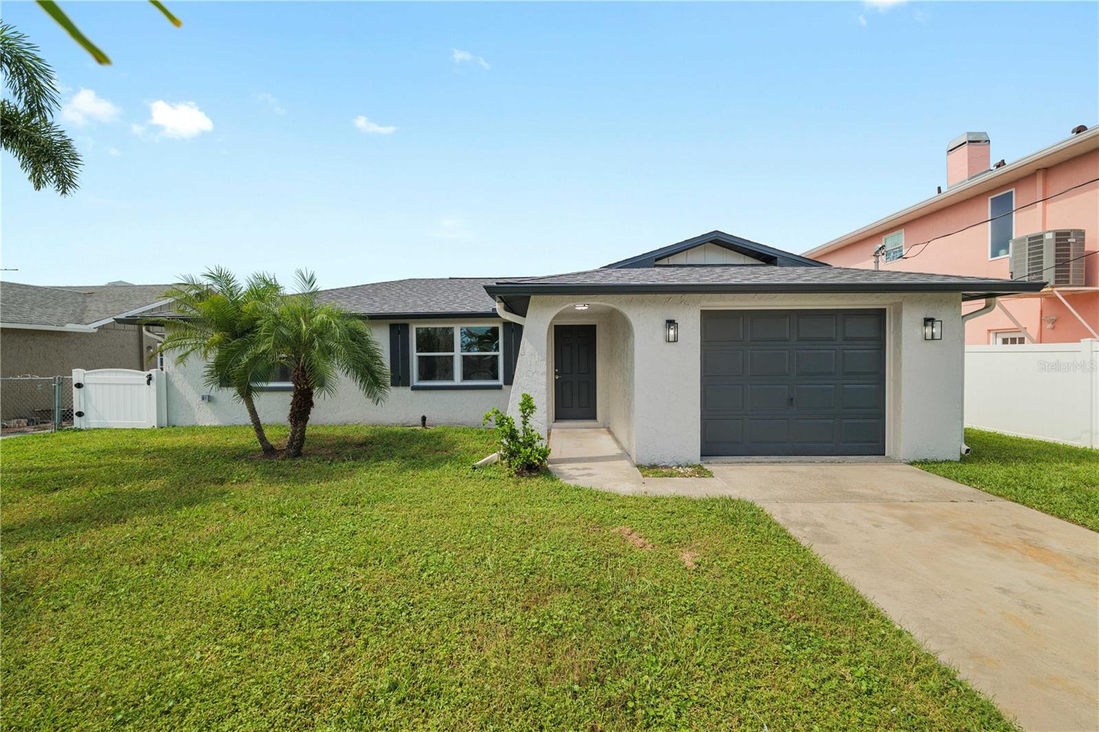 Completely renovated waterfront beauty with direct Gulf access! This stunning home has been fully transformed from top to bottom. There's nothing left to do but move in and enjoy. Go inside to discover new hurricane-impact windows and doors, a new roof and a 2-year-old HVAC system for year-round comfort. Fresh insulation meets energy codes, ensuring efficiency and peace of mind. Every inch shines with new flooring throughout, fresh interior and exterior paint, upgraded trim and new interior doors. The gourmet kitchen is a chef's dream, featuring premium finishes and modern cabinetry. The newly renovated baths showcase stylish tile, updated fixtures and contemporary vanities. The electrical system has been upgraded to current code, complete with new lighting throughout and has a new tankless water heater.