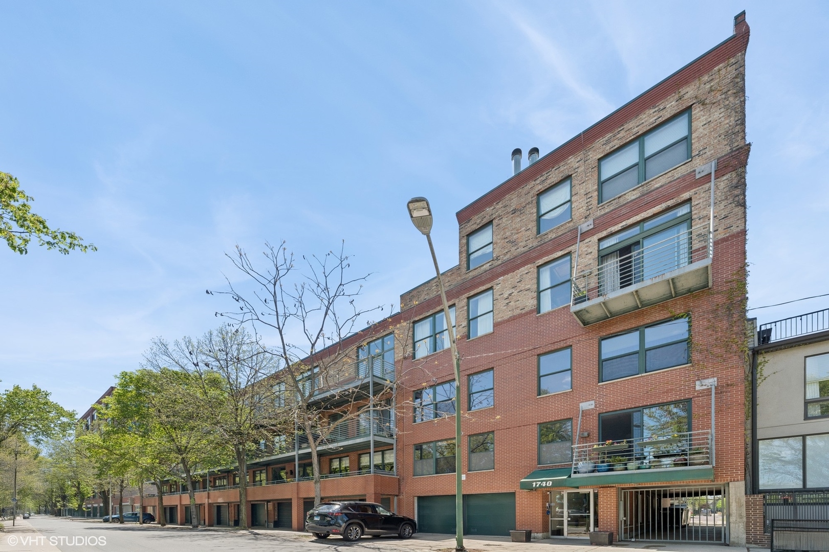 Welcome to Unit 29 at Marshfield Lofts, a coveted boutique building nestled in the heart of Bucktown. This rare, renovated duplex-up timber loft blends vintage industrial character with mid-century modern flair. Featuring 2 bedrooms, 1.5 baths, hardwood floors throughout, exposed brick and beams, and two private balconies. Step inside to find an updated eat-in kitchen with smart finishes and generous storage. The main level boasts an open-concept living room with soaring ceilings, a wood-burning fireplace, and a modern powder room. Up the sleek open-tread staircase, you'll discover a well-designed split-bedroom layout and a spacious full bath complete with double vanities, a skylight, linen closet, and dual access from both the hallway and the primary suite. The primary bedroom easily fits a king bed and includes a custom walk-in closet, overhead storage, and a new washer/dryer. The second bedroom works beautifully as a guest room or home office, with space for a queen bed and desk. Garage parking is included, plus additional space on the exterior parking pad. All just steps from the 606 Trail, charming boutiques, cozy coffee shops, award-winning dining and the best of what Bucktown has to offer. BUILDING IS CURRENTLY UNDERGOING A BALCONY REPLACEMENT PROJECT ON THE NORTH SIDE. This unit faces north / south, the project is set to complete in October weather permitting. Bring your cash offers or reach out for details on special lender financing options!