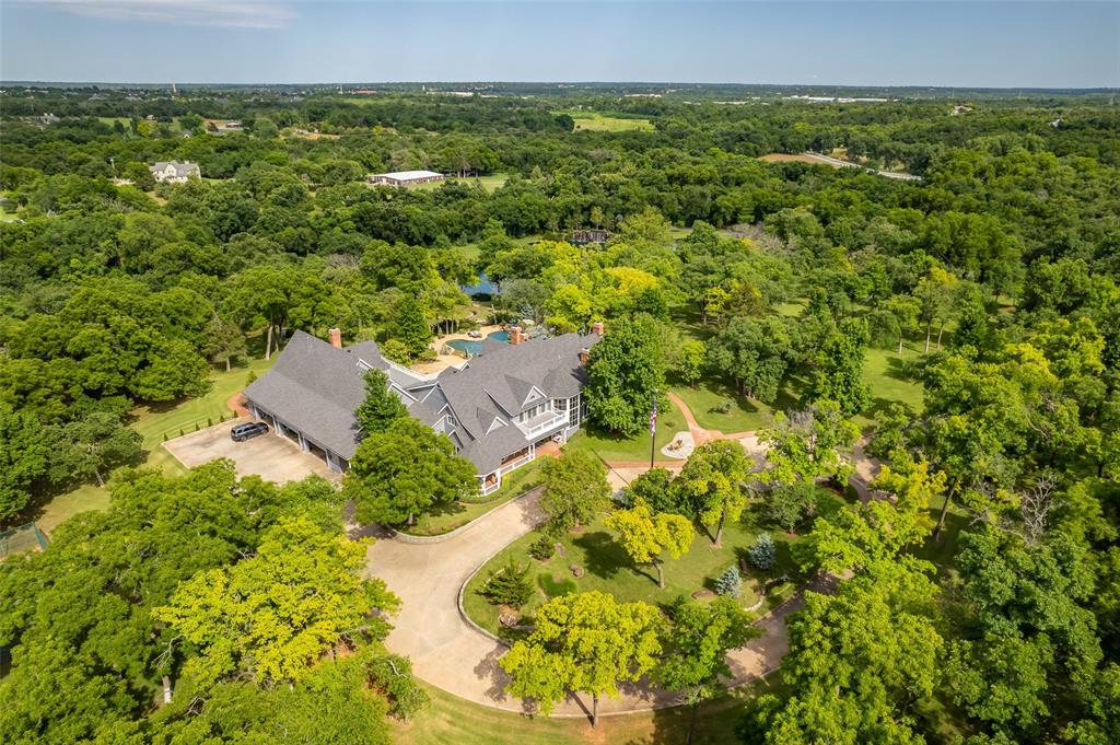Welcome to An Oasis of Unparalleled Luxury & Tranquility Nestled in the Heart of Northeast Oklahoma City. This 80-Acre Equestrian Estate is a Masterpiece of Elegance & Relaxation. Offering an Extraordinary Lifestyle. At the Core of this Magnificent Property Stands a Breathtaking 10,859-Square-Foot Main Residence. The Grand Entry is Highlighted with a Sweeping Spiral Staircase. The Living Room, Formal Dining & Study are a Perfect Setting for Gatherings. Culinary Dreams Come to Life in the Gourmet Kitchen, Outfitted with Top-Tier Appliances, Custom Cabinets & a Sprawling Granite Island. Beyond the Kitchen is an Enchanting Club Room with a Vaulted Ceiling, Wet Bar, Wine Room & Fireplace. The Large First Floor Primary Suite Includes a Spa Like Updated Bath Featuring a Floating Soaking Tub, Fireplace & an Oversized Walk-In Fitted Closet. There is a First Floor Guest Suite with a Full Bath. The Finished Basement Hosts a Bonus Room that Could Be a 5th Bedroom & is Complete with Full Bath, Steam Shower & Dry Sauna. The Main House Includes a Spacious Six Car Garage. Equestrian Enthusiasts will Find Delight in the Horse Barn, an Impressive Indoor Arena & All the Comprehensive Amenities. An Additional Large Equipment Barn Adds to the Property's Versatility & Function. The Estate’s Outdoor Amenities are an Entertainer’s Dream: A Resort-Style Pool with a Swim-Up Bar & Cascading Waterfall. Enjoy a Peaceful Retreat by the 2-Acre Pond, Complete with its Own Waterfall. Perfect Your Golf Game at the Private Range & Putting Green or Host Matches at the Tennis Court. A separate 3,124-Square-Foot Home on the Property Offers Additional Living Space for Guests or Property Staff. Prime Location Conveniently Situated South of the Kirkpatrick Expressway & West of I-44. Short Drive to Nichols Hills & Downtown Oklahoma City.  This Estate Blends Privacy with Accessibility. Discover the Epitome of Serenity & Sophistication at this Unrivaled Oklahoma City Luxury Estate.