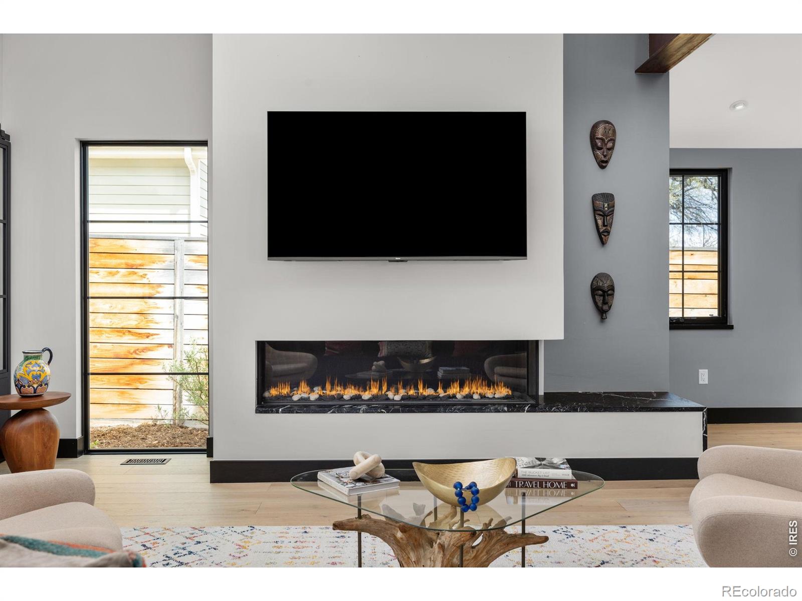 Experience Boulder living at its best. Just minutes from downtown, by foot, bike, or bus, this modern Newlands home puts you at the center of the city's music festivals, top dining, shopping, and entertainment. A compelling investment or primary residence, the property has rented between $12,000-$15,000/month. Designed for versatility, it lives like a single-family home with the ease of a condo, low-maintenance yard, no HOA, attached two-car garage, and a private fenced outdoor space. Inside, sunlight pours through expansive Marvin windows, illuminating an open-concept layout with exposed steel beams and elevated finishes throughout. The show-stopping kitchen features a 10-foot Noire soapstone island, Calacatta Gold countertops, and premium Thermador, Zephyr, and Emerald appliances, perfect for entertaining. The living room centers around a 70" Flare fireplace, while Belgian barn doors reveal a flexible office or guest suite with a full en-suite bath. Upstairs, bright bedrooms capture sweeping Flatiron views, and the primary suite offers a serene retreat with a spa-like en suite and a spacious walk-in closet. Modern, light-filled, and ideally located, this home is ready for festival weekends, everyday living, and everything that makes Boulder so dynamic. Get up to $8,000 in lender-paid concession to cover closing costs or buy your rate down!