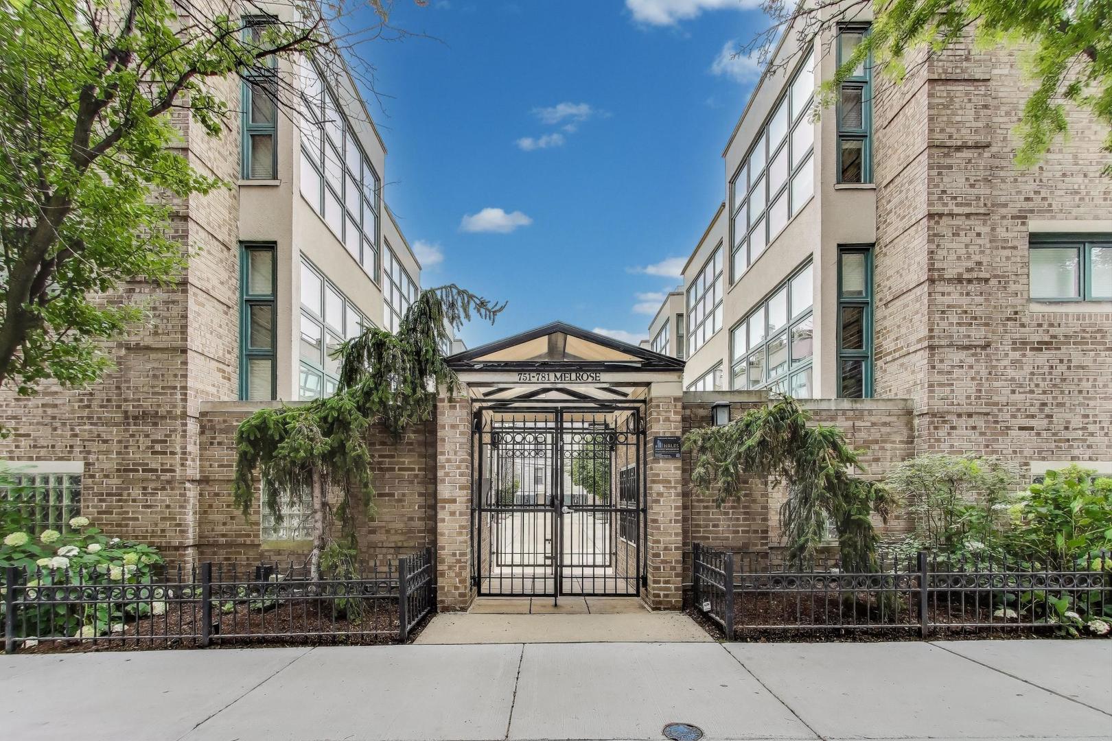 Welcome to this impeccably maintained and beautifully updated 3 bedroom, 3 bath townhome nestled in a quiet, gated community in the heart of Lakeview. This rarely available home lives like a single-family, offering four full levels of living space, multiple private outdoor areas, and an attached garage with direct interior access. Step into the spacious entry foyer with a large cart closet and onward to a full en suite bedroom that opens to a private patio, ideal for guests, a home gym, or a quiet office setup. Upstairs, the main living level is flooded with natural light from floor to ceiling windows. White oak hardwood floors run throughout, and the generous open layout includes a large living room with a marble surround gas fireplace, a separate dining area, and a sleek updated kitchen with quartz countertops, stainless steel appliances, and breakfast bar seating. On the third level, you'll find two spacious bedrooms with hardwood floors and ample closet space. The front-facing primary suite features dramatic windows, space for a king-sized bed, and a modern en suite bath with a dual vanity, a walk-in shower with bench seating, and dual shower heads. The second bedroom has easy access to an updated hallway bath with a floating vanity and soaking tub. A full-size side-by-side LG washer and dryer is also located on this level, just outside the main bedrooms-a rare and convenient feature in this complex. The top floor offers a bonus flex space perfect for a home office, reading nook, or media area. From here, step out onto two private rooftop terraces finished with Trex decking, ideal for relaxing or entertaining. With most daily living happening on the second and third floors, you are not constantly going up and down. This gated community offers peace of mind and a neighborly atmosphere. Residents look out for one another, keep an eye on packages and open garages, and occasionally gather for courtyard potlucks. All just minutes from the lakefront, Whole Foods, Target, Wrigley Field, public transit, countless shops, restaurants, and more.