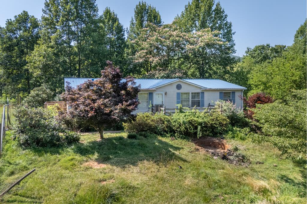Situated on approximately 1.9 private acres, this 3-bedroom, 2-bath home offers 1,400 square feet of living space and an excellent opportunity for homeowners or investors alike. The spacious primary suite provides a comfortable retreat, while the large yard offers plenty of room for outdoor living, gardening, or recreation. Nestled on a beautiful, scenic road, this property combines peaceful country living with the convenience of being just a short drive from Mount Airy, NC. Whether you're looking for an investment property or a place to make your own, this home is full of potential.