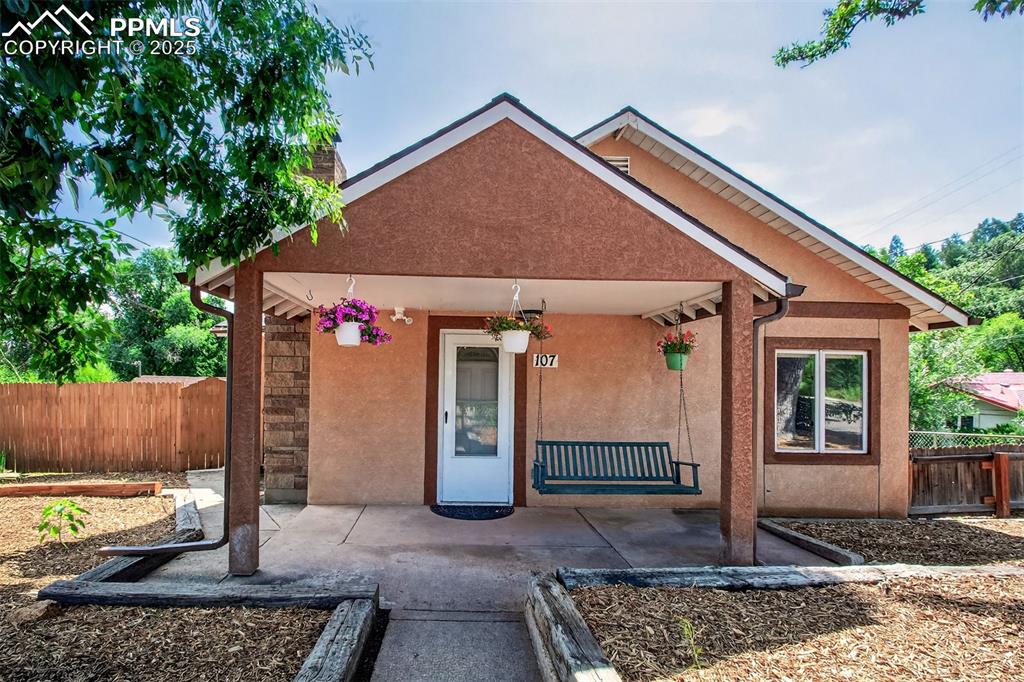 Welcome to a retreat in the heart of Manitou Springs, where timeless charm meets modern convenience and mountain views greet you from nearly every window. This beautifully updated 3-bed, 2-bath home offers over 1,800 square feet of comfortable living space and sits on a spacious lot with mature trees, lush landscaping, and ample room to grow. Inside, enjoy refinished hardwood floors, fresh paint, and new flooring in the bedrooms. The remodeled upper bath, wood-burning fireplace, and walkout dining area with a mountain-facing patio set the stage for cozy everyday living. The kitchen features SS appliances, including a gas self-cleaning oven with an air fryer and griddle. Flex spaces provide ideal areas for an office, studio, or home gym. The home has been thoughtfully upgraded with new windows, a Class 4 impact-resistant roof, new 3/4 sheeting, insulated ceilings, newer steel gutters, an upgraded electrical panel, a QuietCool whole-house fan, a thermostat-controlled attic fan, humidifier, and a newer water heater—offering lasting comfort and efficiency. Step outside to enjoy fresh landscaping, raised garden beds with new soil, newer fencing, a backyard shed, a sweet built-in catio, and a fenced yard perfect for pets or play. Sip your morning coffee on the porch swing, shaded by mature trees and surrounded by nature. The corner lot offers generous yard space, while ample parking wraps around the property, providing rare convenience in Manitou Springs. What sets this home apart is its ADU potential: the garage was set to become an income-producing unit and includes architectural plans, documentation, and some materials already on site. With Manitou Springs offering funding and incentives for ADUs, this is a golden opportunity for added value, rental income, or multi-generational living. Nestled in a friendly neighborhood, mountain views from nearly every room, and no shortage of charm,  is your chance to own a unique piece of Manitou magic.