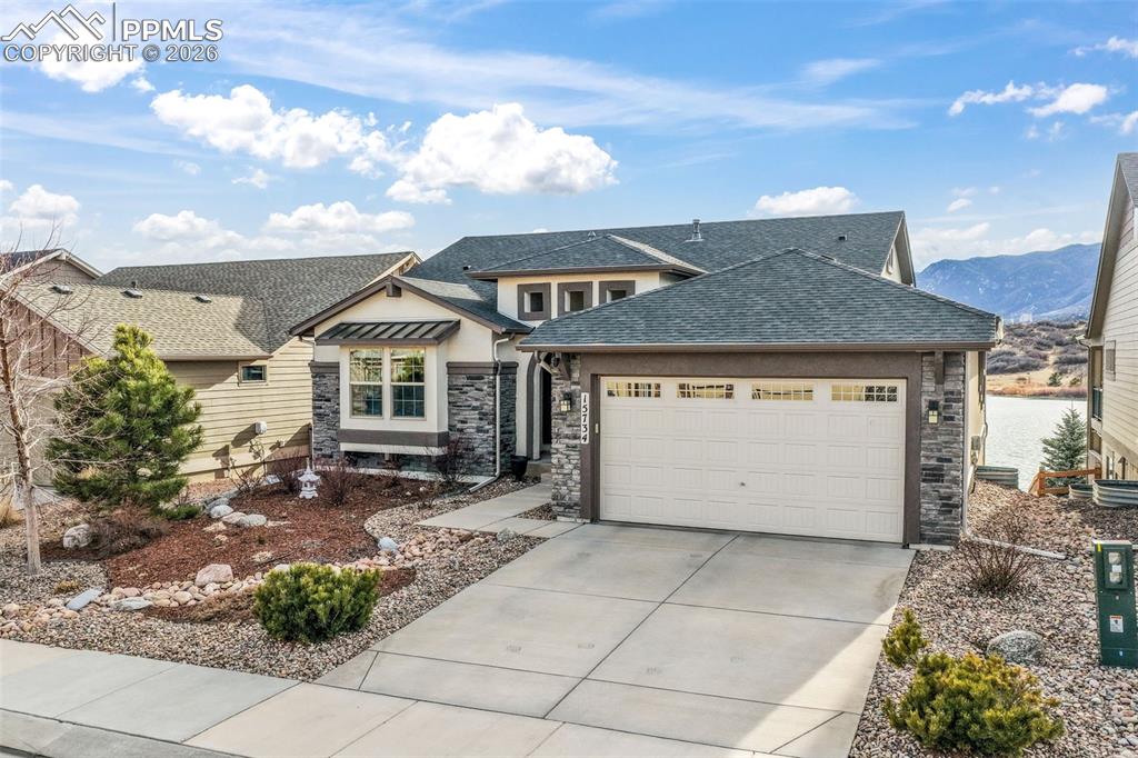 Perfectly positioned in a quiet cul-de-sac, this stunning ranch home by Classic Homes offers unmatched views with green space in front and the lower lake behind. The striking stone-and-stucco exterior, arched covered entry, and beautifully designed landscaping create unforgettable curb appeal, while the oversized garage features a 4' extension and 9' doors to accommodate larger vehicles. Inside, a private office with double French doors, bright windows, and a charming window seat sits just off the entry, along with a convenient powder bath. The main living area is open and filled with natural light, drawing your attention immediately to the breathtaking scenery beyond. The gourmet kitchen showcases upgraded granite countertops, enhanced cabinetry, stainless steel appliances, a gas stove, walk-in pantry, and an expansive island that flows effortlessly into the dining area and spacious living room. Anchored by a custom Kiva wood-burning fireplace, the living room offers warmth, character, and direct access to the large composite deck — the perfect place to take in the incredible lake views. The main-level primary suite is a peaceful retreat with abundant windows and private deck access. The spa-inspired bathroom features a soaking tub, oversized walk-in shower with bench, and generous walk-in closet. The walkout basement expands the living space with a large recreation room opening to the back patio, three additional bedrooms with walk-in closets, including an en-suite, plus a sizable storage area. Enjoy Colorado living from both upper and lower outdoor spaces, surrounded by a beautifully landscaped yard. Additional highlights include AC and smart home features. Forest Lakes offers walking trails, a lake for water recreation, quick access to I-25 for commuting to Denver or Colorado Springs, and close proximity to the Air Force Academy and downtown Monument’s shopping & dining. More than a home, this is a lifestyle defined by views, comfort, and exceptional design.