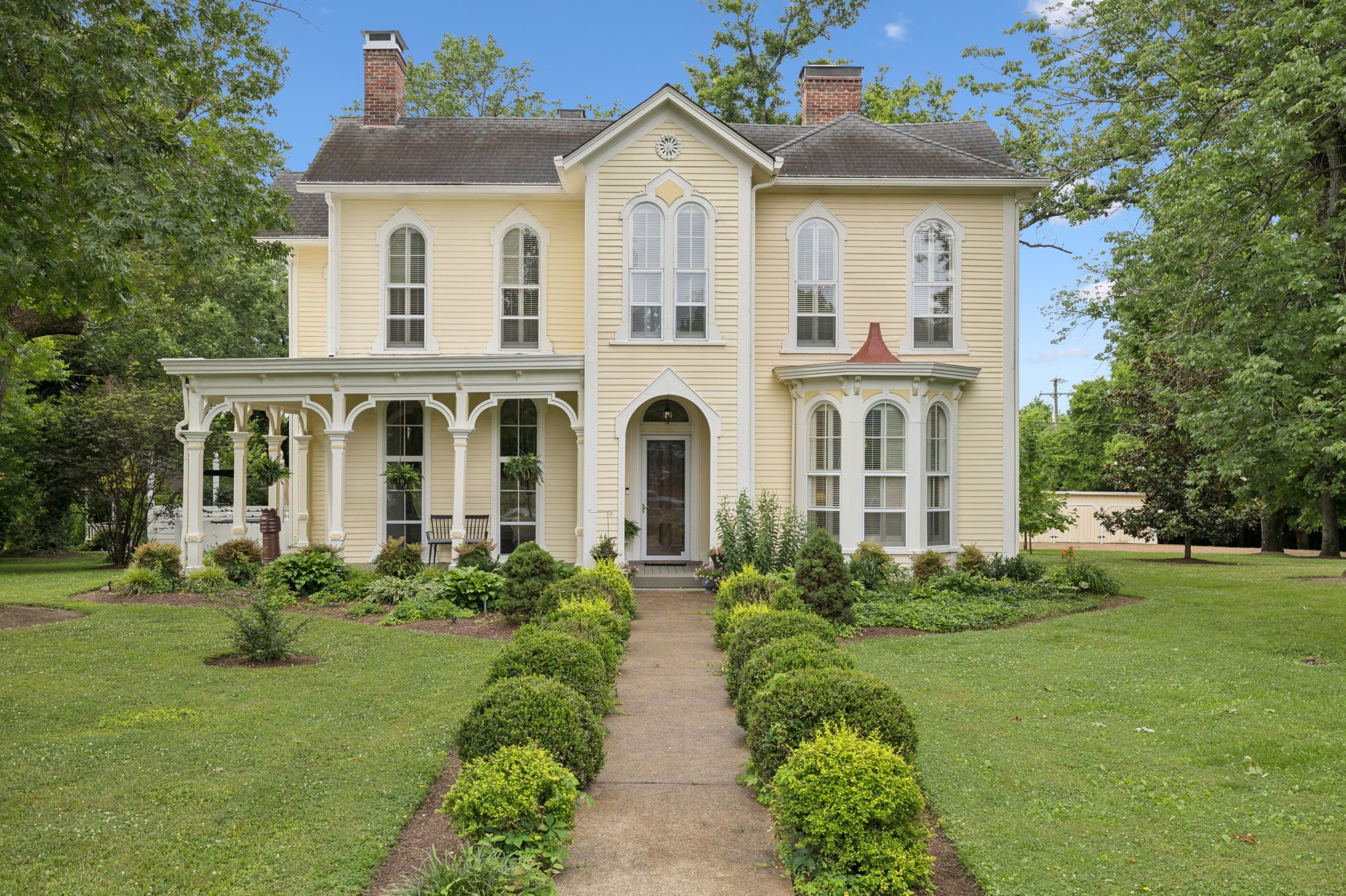 The Robert Chadwell Home also known as The Idlewild Mansion is situated on a wooded, two-acre lot in heart of Madison's Neelys Bend. Built in 1859, the rare Italianate is as rich in style as it is in history and is listed on the National Register of Historic Places. The 4000+ square foot home found its perfect owners who lovingly restored it to its former glory and are now bringing it to the market for first time 15 years later. When you enter, you immediately notice the home is in its original pristine condition, however virtually every historic aspect has been painstakingly preserved or carefully replicated to a modern or improved version of the original. Soaring ceilings, transom windows, original windows, and antique hardwoods call you back to the 1800s while a modern, reimagined kitchen and stunning owner's bathroom and wet area make you grateful for today's conveniences. Beyond the home, you'll discover additional buildings and studios. Lucinda's Cottage is a profitable short-term rental AirBnB that complements the main home and has a central stone fireplace and hypoallergenic environment. An enormous barn is nestled next door which can be imagined for almost any usage you can dream of. The first level has a huge open space while the second level has a studio perfect for bridal prep or entertainment. Outside the structures, the grounds are absolutely glorious. Stroll through the meticulously kept gardens for solace in a picture-perfect gazebo. Rest under the shade of some of the largest, most robust trees in the area. Enjoy the 636 acre Peeler Park and its miles of walkways and equestrian trails minutes from the home on Neelys Bend. Madison has quickly risen to mirror its neighboring East Nashville/Inglewood for the hippest places to enjoy. Whether it's Pinky Ring Pizza, Yazoo Brewery, Shotgun Willie's BBQ, Amqui Farmer's Market, or new venue, Harken Hall, you'll be in the heart of it all, and only 15 minutes from downtown and the airport.