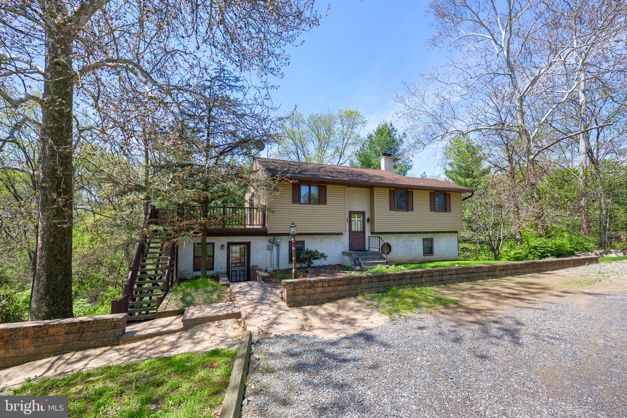 Set on a scenic .9-acre lot in a wooded setting that backs to a stream and overlooks preserved farmland across the street, this Warwick Township home offers a peaceful backdrop with everyday convenience just minutes from Rt 222. Originally a one-story home, the property was fully rebuilt in 1985 on the existing foundation, creating a spacious layout that now includes 4 bedrooms and 1.5 baths. Inside, you’ll find a custom-designed kitchen that serves as the heart of the home, flowing easily into the main living areas and out to a large composite deck—perfect for relaxing or entertaining while taking in the natural surroundings. The lower level expands your living space with a comfortable family room featuring a propane stove, along with an additional unfinished level that provides plenty of storage or room to grow. Outside, the large front yard offers space to enjoy gardening, complete with a garden area and shed, while a stamped concrete walkway welcomes you home. A great opportunity to enjoy a quiet setting without sacrificing convenience—schedule your showing today.