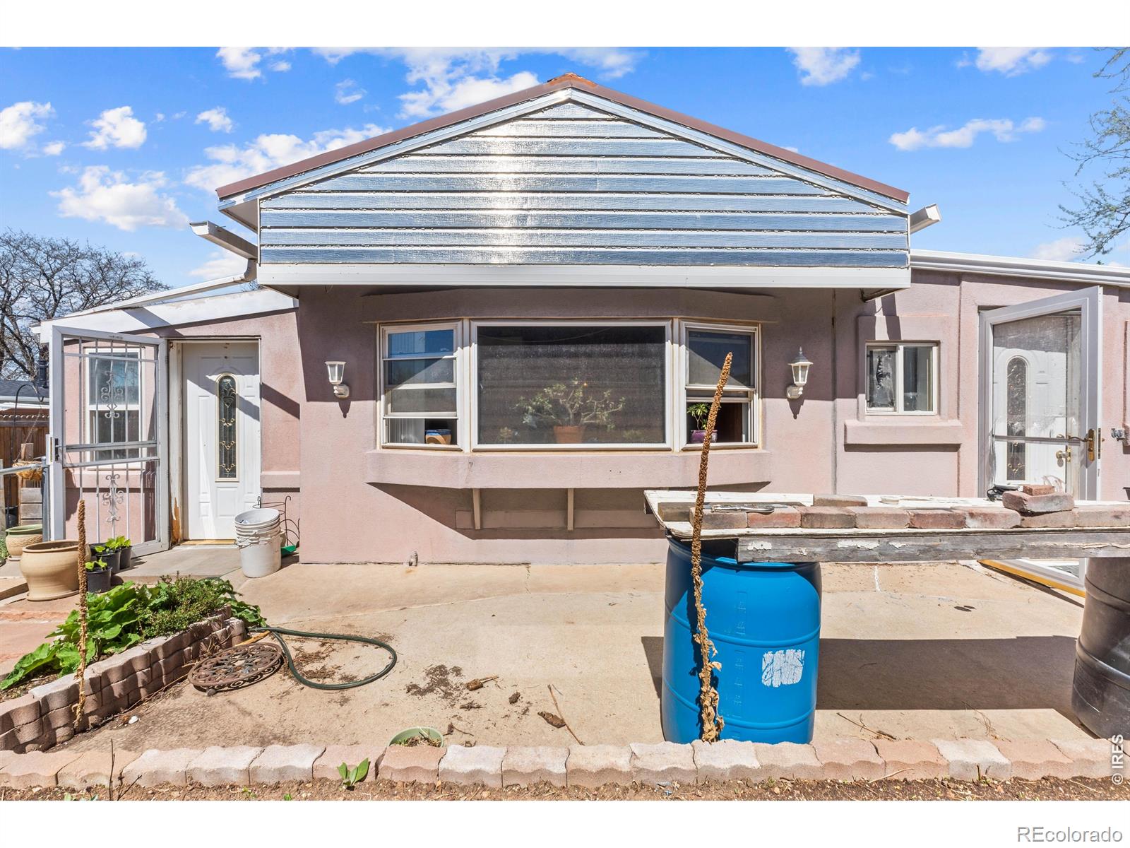 Seller will consider Owner Carry with 30% down- contact agent for more info. Incredible investment opportunity: tear down and rebuild or fix up and earn sweat equity. This purged manufactured home sits on one of the largest lots in the neighborhood with no HOA and no lot fee. Being sold as-is, it offers tremendous potential for those willing to put in sweat equity for a great return. Featuring 4 non-conforming bedrooms and 2 bathrooms, the home has rental potential once renovated and provides a functional layout ready for your vision. The oversized two car detached garage includes multiple storage rooms. Above is an unfinished apartment/potential ADU with rough-ins for a bathroom, laundry, and a kitchen setup- perfect for additional rental income once completed. If considering tearing down, the utilities are already at the property and by rebuilding with a HUD tagged home, the value of the property can increase substantially. The property sits on one of the largest lots in the neighborhood, backing to a greenbelt, offering privacy, a fruitful peach tree, garden area, greenhouse, and plenty of room for outdoor projects. Priced for buyers seeking a project, this property offers rare investment and income opportunities. *****Due to the age of the home (pre 1976), this sale is cash only, hard money loan (if available), or seller financing.*****