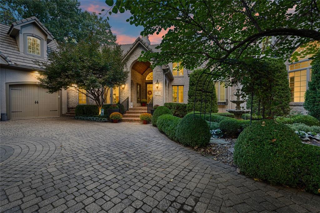 Welcome to Your Private Lakefront Sanctuary Designed for effortless daily living and high-end hosting, this exquisite estate seamlessly blends classic sophistication with modern warmth. At the heart of the home, the freshly renovated chef’s kitchen features quartz countertops, custom cabinetry, a walk-in pantry, and premium Wolf, Sub-Zero and Cove  appliances, flowing into a sunlit hearth room with a fireplace and serene lake views. The main level also offers a home office, formal dining room, two-story living room with porch access, and a main laundry room with a built-in desk. Through the stone-accented library with custom built-ins and a fireplace lies the primary retreat. The suite boasts a barreled ceiling, sitting room with fireplace, and a refreshment station with a fridge and sink. The spa bath features dual vanities, a makeup station, rainfall shower, Jacuzzi tub, and walk-in closet with laundry. A circular staircase leads directly down to a private workout room. A secondary primary suite acts as a luxurious guest wing, featuring its own fireplace, beverage center, private balcony, full bath with a Jacuzzi tub, walk-in closet, and two attached bonus rooms. All additional secondary bedrooms feature generous walk-in closets. The expansive lower level is built for ultimate indoor recreation—featuring a private theater room, fully equipped second kitchen, temperature-controlled wine room, workout space, game room, and rec area. The true star of the show is the resort-style outdoor oasis, designed for unforgettable entertaining. Enjoy lush gardens, calming water features, covered living spaces, and decks surrounding a sparkling pool with slide, sun deck, and hot tub. The pool house serves as a full secondary living space with a third kitchen, family and dining areas, bath with laundry, outdoor shower, and basement storage. Includes the adjacent vacant lot at 55 Windsor Court for additional privacy or future options.