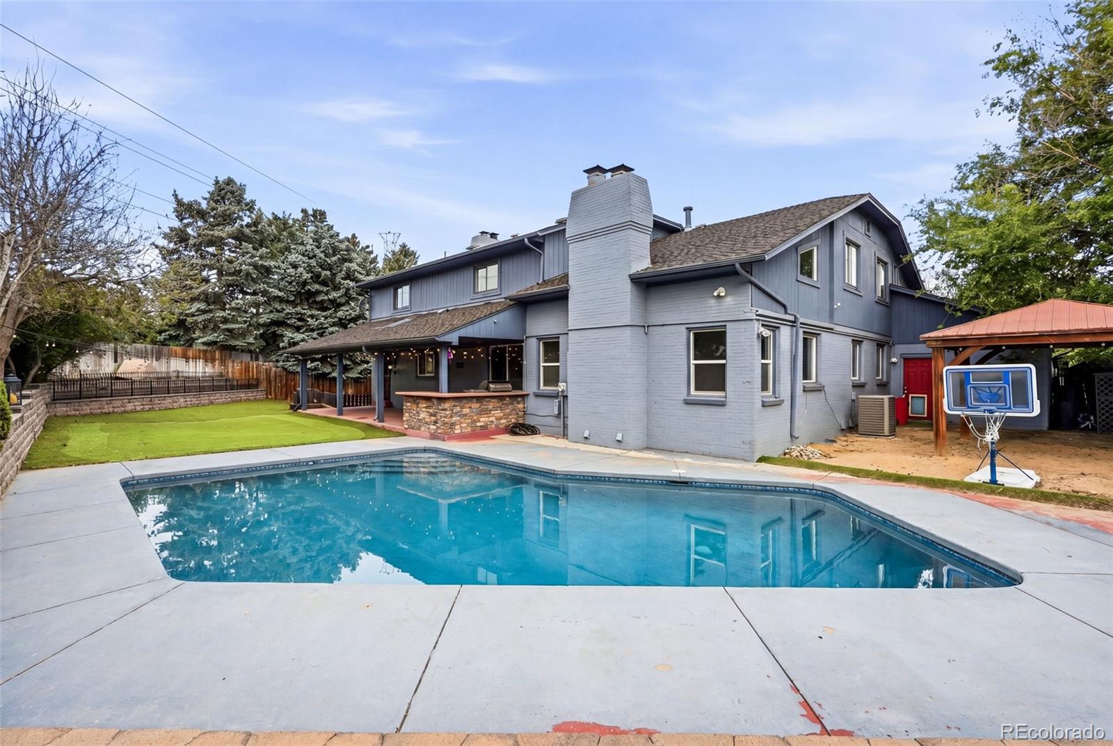 Welcome to 9056 E Colorado Cirlce, a vacationlike retreat in the middle of the city.  Thoughtfully updated, great entertainment flow, an in-ground pool, putting green and outdoor built in kitchen, this home has it ALL!  The front door enters into a foyer, great for dropping coats and boots, and then into the home.  The main level is well laid out, bright, and includes a stylish office, two story family room, formal dining room, and large updated kitchen that opens to a welcoming living room.  Upstairs, a rare and sought after layout includes four large bedrooms; the primary retreat and three very well sized secondary bedrooms.  New carpet throughout the home and fresh paint on the main level.  The basement is fully finished and has room for everything; an additional bedroom and bathroom plus a huge TV space with built in bar setup fill the space.  The backyard is built to feel like a resort.  The outdoor kitchen with built in grill is covered and opens up to the putting green and in ground pool.  A fenced in garden area complete the space and is a blank canvas for your green thumb.  Priced WELL below comps - recent appraisal of $1.4M this home is priced to SELL.