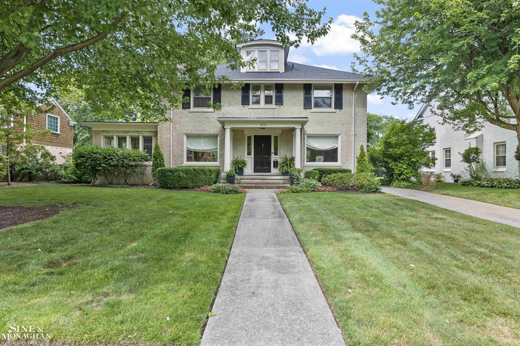 Step into timeless elegance with this stately center-entrance Colonial located in the heart of Grosse Pointe Park. Situated just steps from The Village, and within easy walking distance to schools, parks, and local amenities, this home combines classic charm with everyday convenience. Boasting 4 bedrooms and 3.1 baths, this home offers ideal flexibility for today's lifestyle. The main level is an entertainer's dream and a family's haven, featuring a stunning formal foyer, expansive living room with natural fireplace, elegant formal dining room, and a cheerful sunroom drenched in natural light. The cozy den or family room overlooks the lush backyard-perfect for morning coffee or a quiet read. The kitchen is generous and efficient, while the flow of the main floor invites gatherings both large and small. Radiator boiler heat paired with central air ensures year-round comfort. New Roof in 2024. The spacious second floor features a serene primary suite with private ensuite bath, two additional bedrooms, and a full hall bath. A fourth bedroom and full bath on the third floor provide a perfect space for guests, a home office, or an au pair suite. With gleaming hardwood floors throughout, detailed moldings, and rich architectural character, this home is overflowing with warmth and sophistication. A rare 3-car detached garage offers ample parking and storage space-ideal for families or car enthusiasts. Charming covered front porch, ideal for greeting neighbors or enjoying a summer evening. The rear deck offers the perfect spot for alfresco dining, while the professional landscaped and fenced backyard provides privacy, green space, and peace - a true retreat in the Park. Don't miss your chance to own a slice of Grosse Pointe Park history with modern livability in one of the area's most desirable locations.