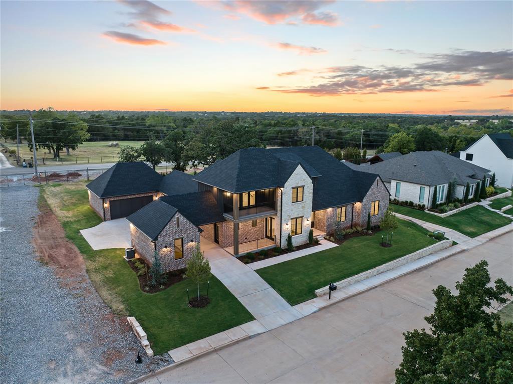 Welcome to a breathtaking residence of distinction in the prestigious golf community, Oak Tree West at 6201 Canopy Ln, Edmond, Oklahoma. Thoughtfully crafted to blend unparalleled sophistication with modern functionality, this architectural masterpiece promises an exceptional living experience. From the moment you enter into the grand foyer, you’ll be greeted by soaring ceilings and exquisite design details that set the tone for this extraordinary home. The heart of the home is the expansive great room, where a statement fireplace, and seamless access to the chef-inspired kitchen create an ambiance of effortless elegance. The kitchen is a culinary dream, Thermador gas range with 2 ovens, full size built-in Refrigerator & Freezer by Frigidaire, quartz countertops, an oversized island, an elegant dining area, and a walk-in butler’s pantry that redefines convenience and storage. The primary suite is a sanctuary of indulgence, featuring a spa-like en suite with an oversized shower, a freestanding pedistal bathtub, and a custom designed closet with stackable washer & dryer connections. . This home also offers an upstairs versatile flex space, ideal for a private media room. Don't miss the home management center. Showcasing exceptional craftsmanship and design. The backyard is perfect for hosting barbecues, playing with family, or enjoying quiet evenings under the stars. Crafted with meticulous attention to detail, this home features top-of-the-line finishes. Highlights: Pella Windows; Full Guttering; Upstairs Walk-in attic storage; Post Tension Foundation; and 3 1/2 car garage. Nestled in the Oak Tree West Golf Community, this neighborhood combines tranquility with accessibility. With its sophisticated contemporary design, meticulous craftsmanship, and luxurious features, this home offers a rare opportunity to experience elevated living. Welcome to your dream home, where luxury, comfort, and elegance converge. Welcome Home!